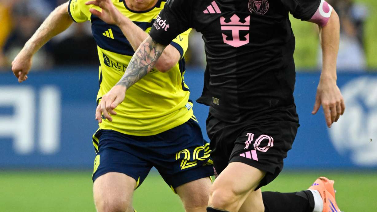 Inter Miami forward Lionel Messi (10) dribbles up the field as Nashville SC midfielder Edvard Tagseth (20) defends during the first half of a MLS soccer match Saturday, Oct. 28, 2025, in Nashville, Tenn.