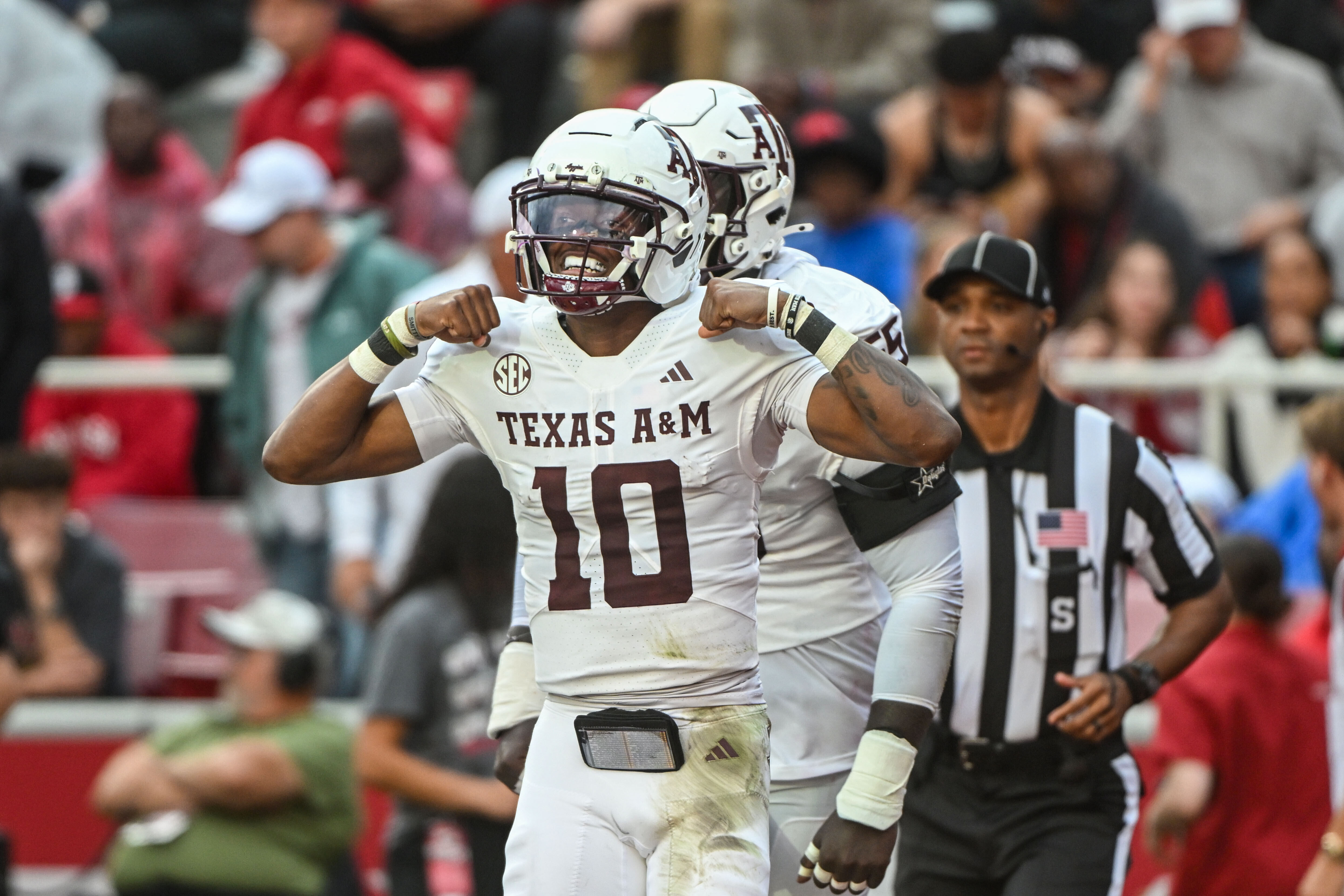Texas A&M quarterback Marcel Reed (10) celebrates after running for a touchdown against Arkansas during the first half of an NCAA college football game Saturday, Oct. 18, 2025, in Fayetteville, Ark. 