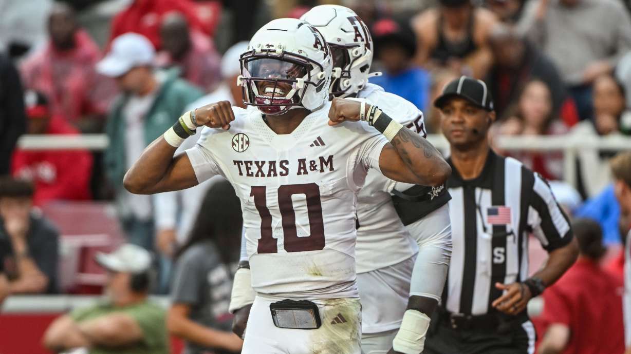 Texas A&M quarterback Marcel Reed (10) celebrates after running for a touchdown against Arkansas during the first half of an NCAA college football game Saturday, Oct. 18, 2025, in Fayetteville, Ark.