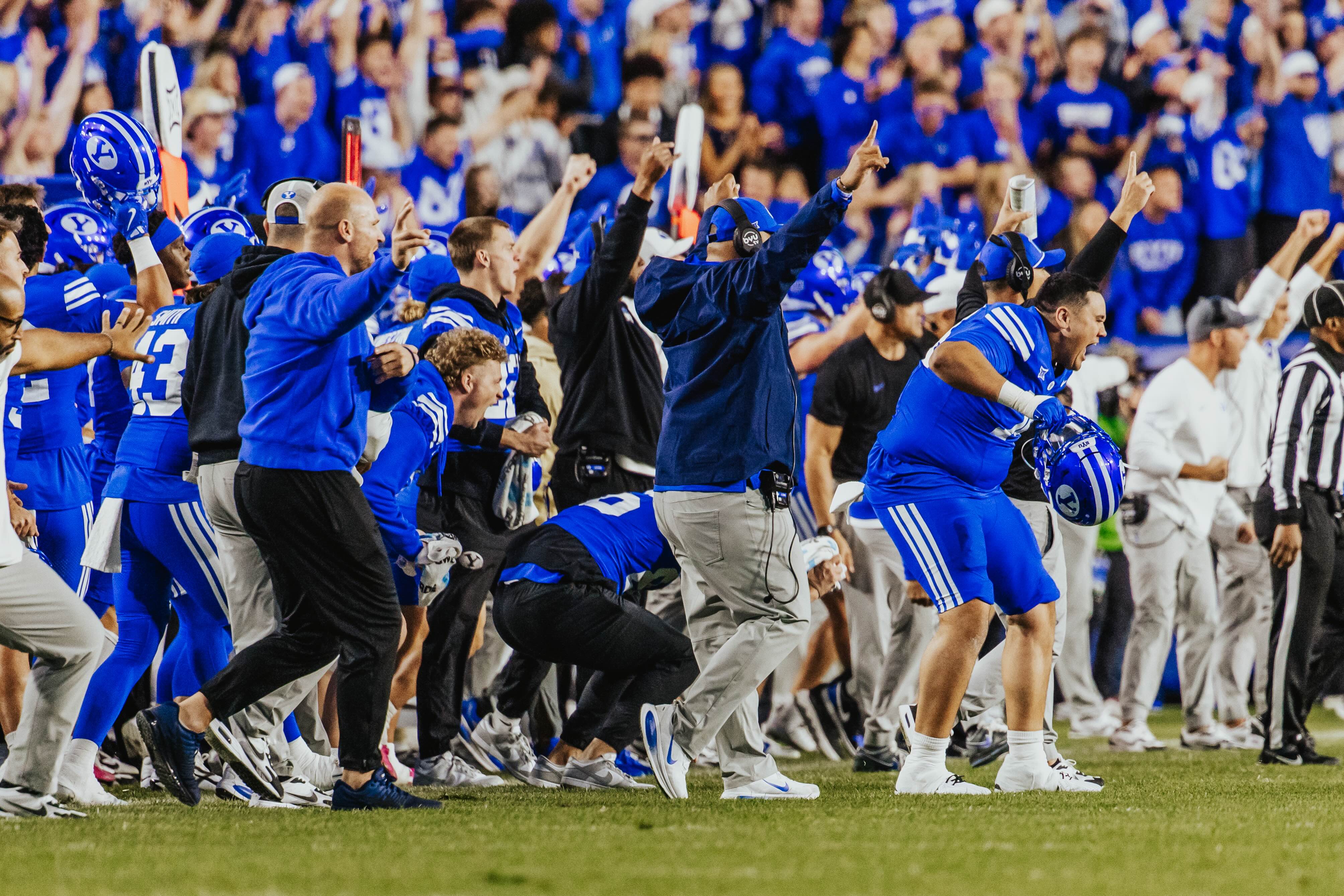 BYU coach Kalani Sitake, middle, celebrates a play during a Big 12 football game against Utah, Saturday, Oct. 18, 2025 at LaVell Edwards Stadium.