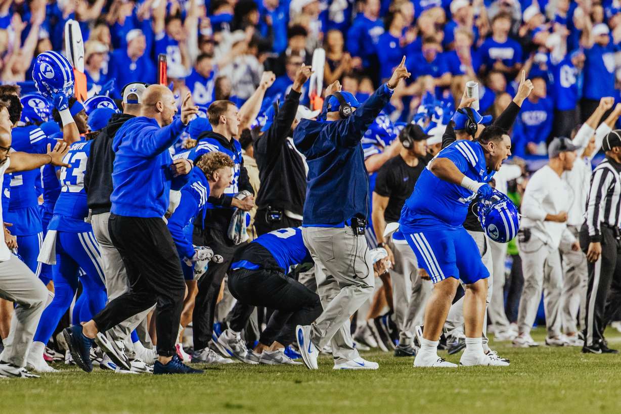BYU coach Kalani Sitake, middle, celebrates a play during a Big 12 football game against Utah, Saturday, Oct. 18, 2025 at LaVell Edwards Stadium.
