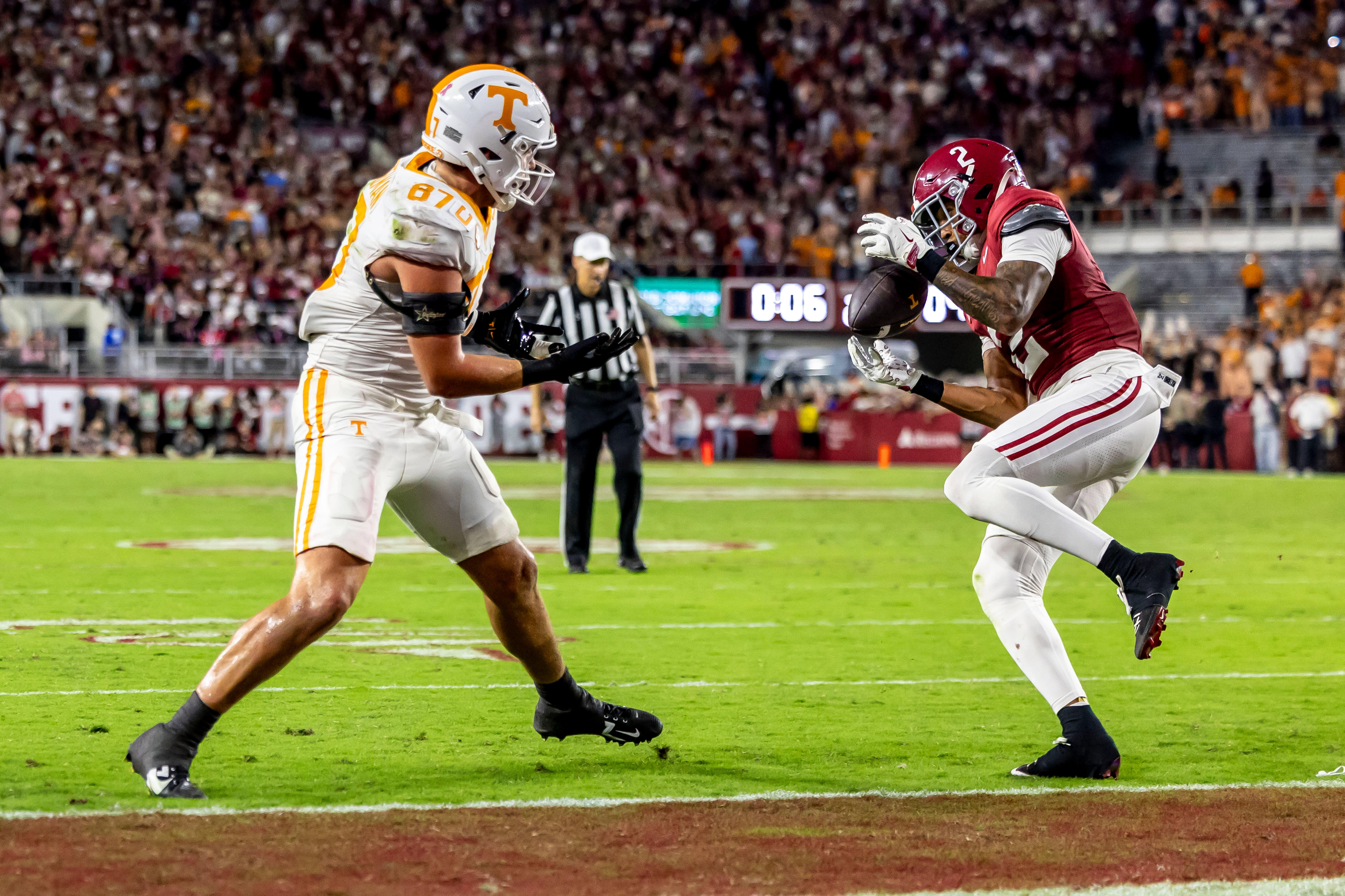 Alabama defensive back Zabien Brown (2) grabs an interception meant for Tennessee tight end Miles Kitselman (87) and returns it 99 yards for a pick-six touchdown on the final play of the first half during an NCAA college football game, Saturday, Oct. 18, 2025, in Tuscaloosa, Ala. 