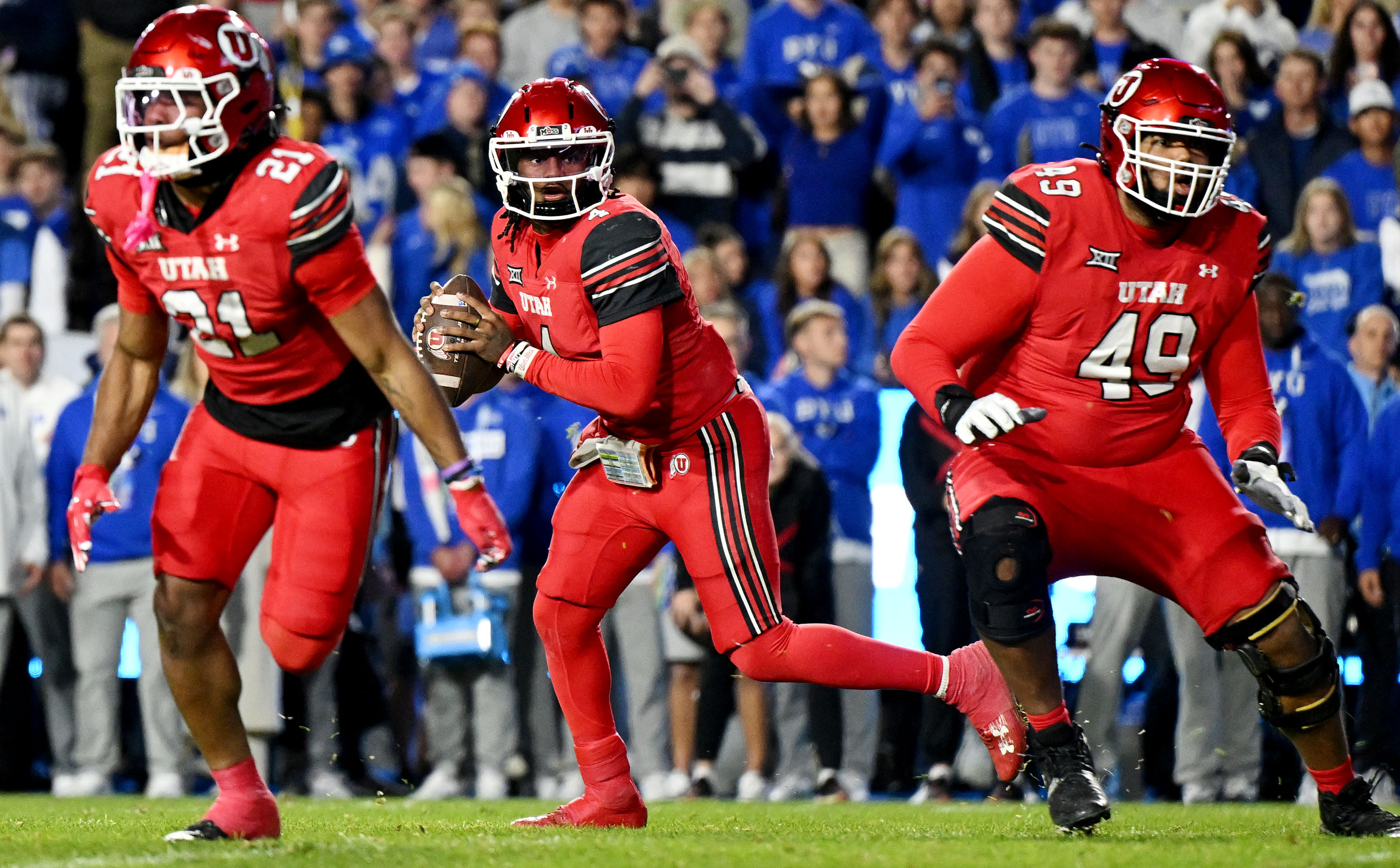 Utah quarterback Devon Dampier (4) spins after taking the snap and looks downfield as BYU and Utah play at LaVell Edwards Stadium in Provo on Saturday, Oct. 18, 2025.