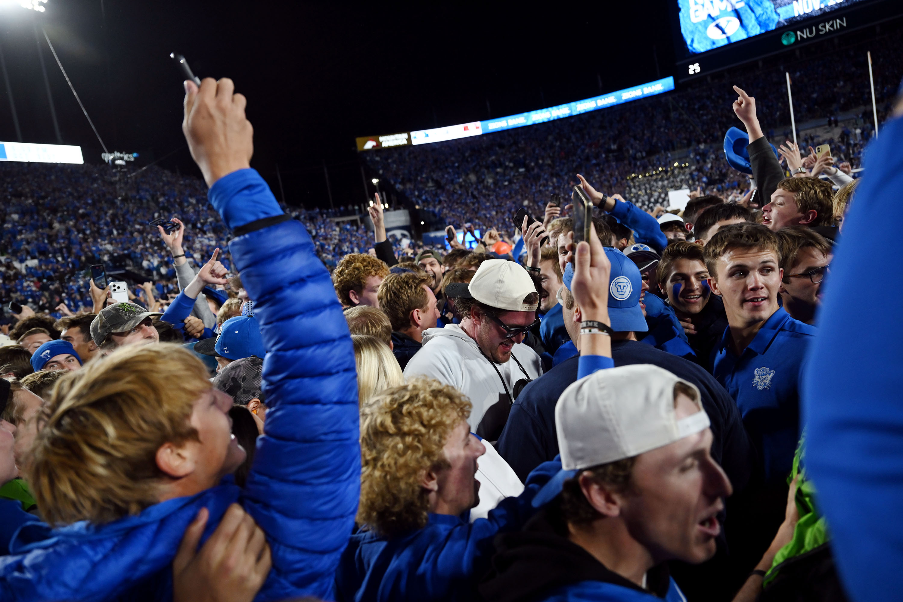 Fans rush the field after the game as BYU defeats Utah 24-21 at LaVell Edwards Stadium in Provo on Saturday, Oct. 18, 2025.