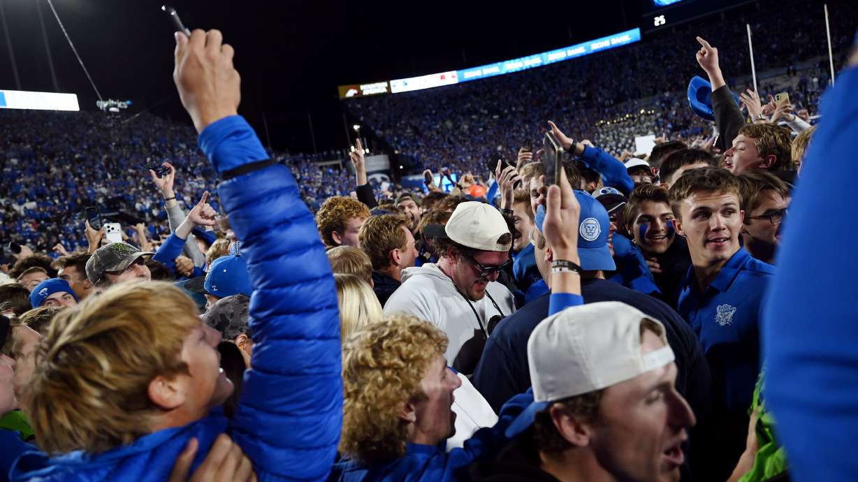 Fans rush the field after the game as BYU defeats Utah 24-21 at LaVell Edwards Stadium in Provo on Saturday, Oct. 18, 2025.