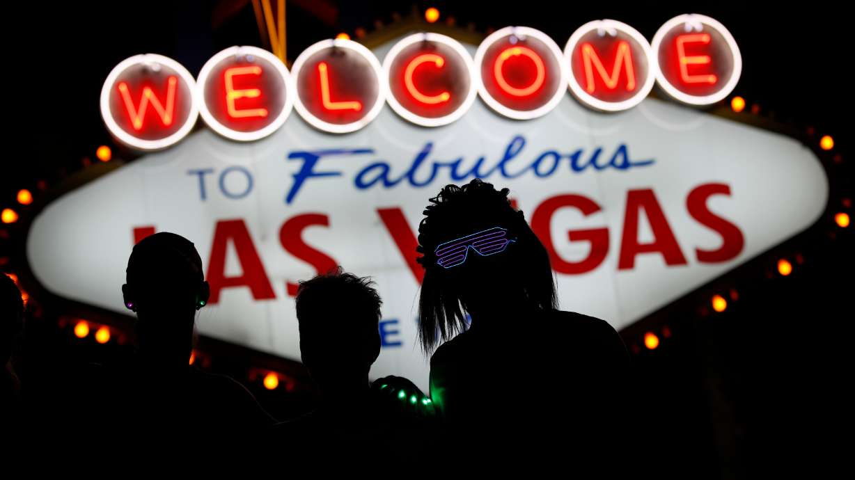 Runners stop to to have photos taken at the Welcome to Las Vegas sign Nov. 12, 2017. Nevada labor unions hoping to boost jobs and tourism are pushing state officials to offer tax credits aimed at bringing more Hollywood filmmaking to the state.