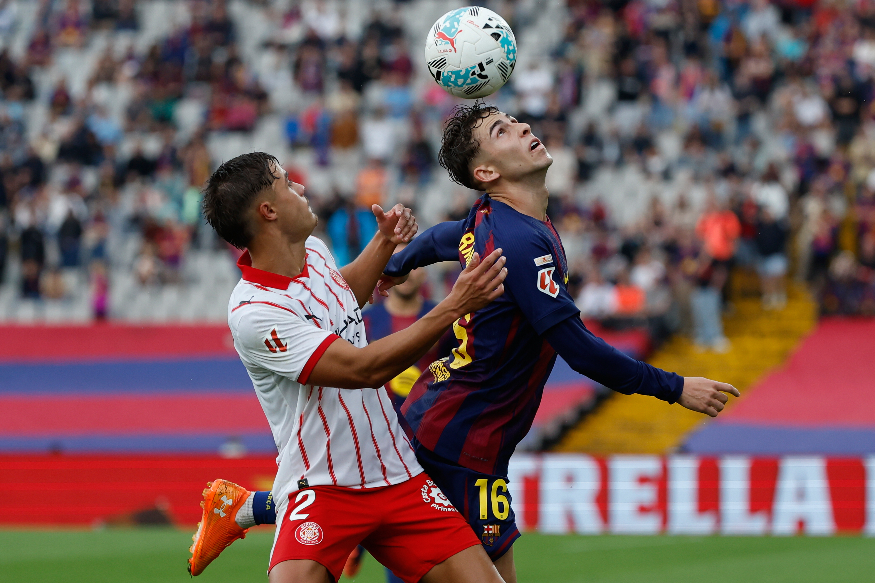Girona's Hugo Rincon, left, and Barcelona's Fermin Lopez fight for the ball during a La Liga soccer match between Barcelona and Girona in Barcelona, Spain, Saturday, Oct. 18, 2025. AP Photo/Joan Monfort)