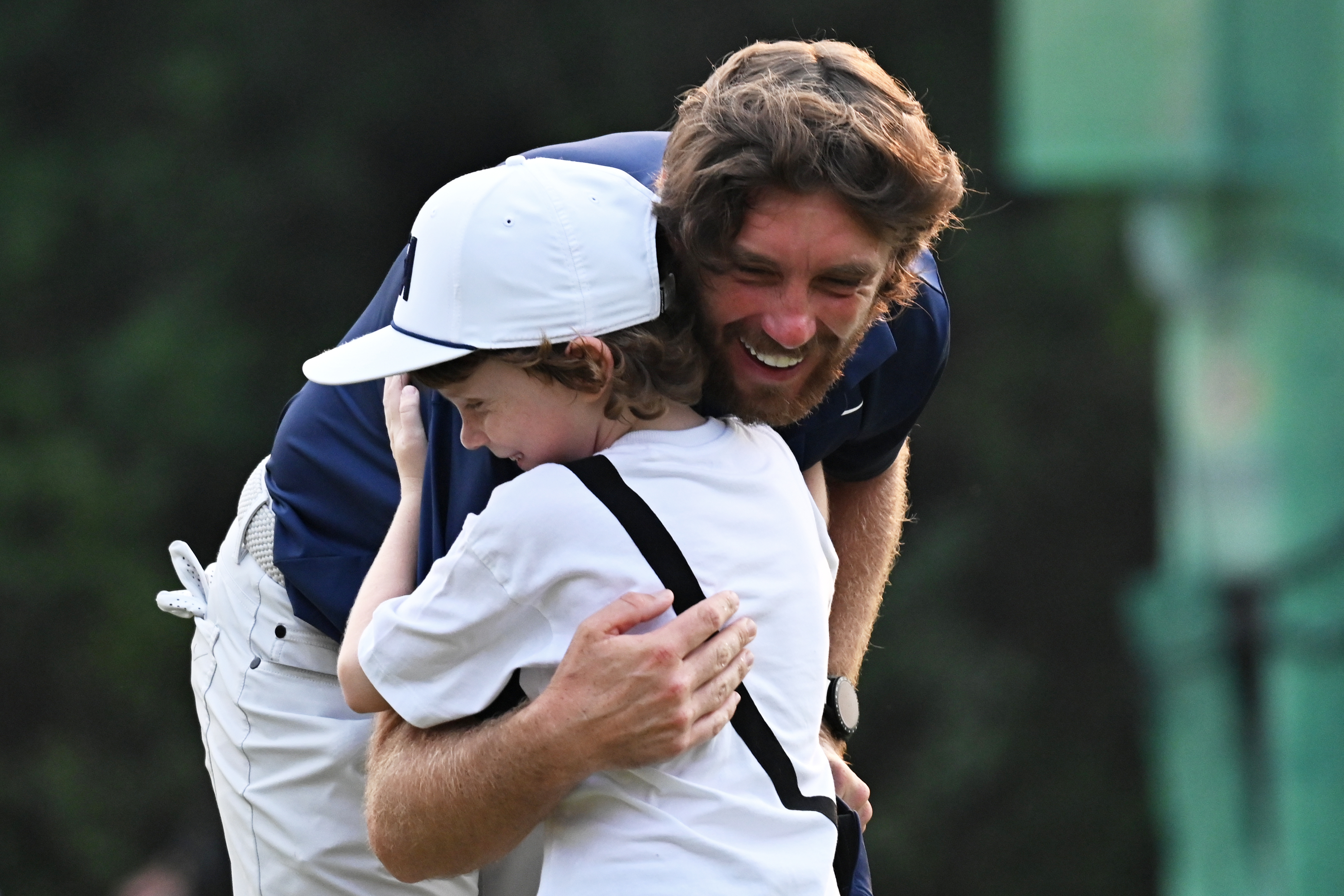 Tommy Fleetwood of England hugs his son Frankie after wining the DP World Tour Championship golf tournament in New Delhi, India, Sunday, Oct.19, 2025.