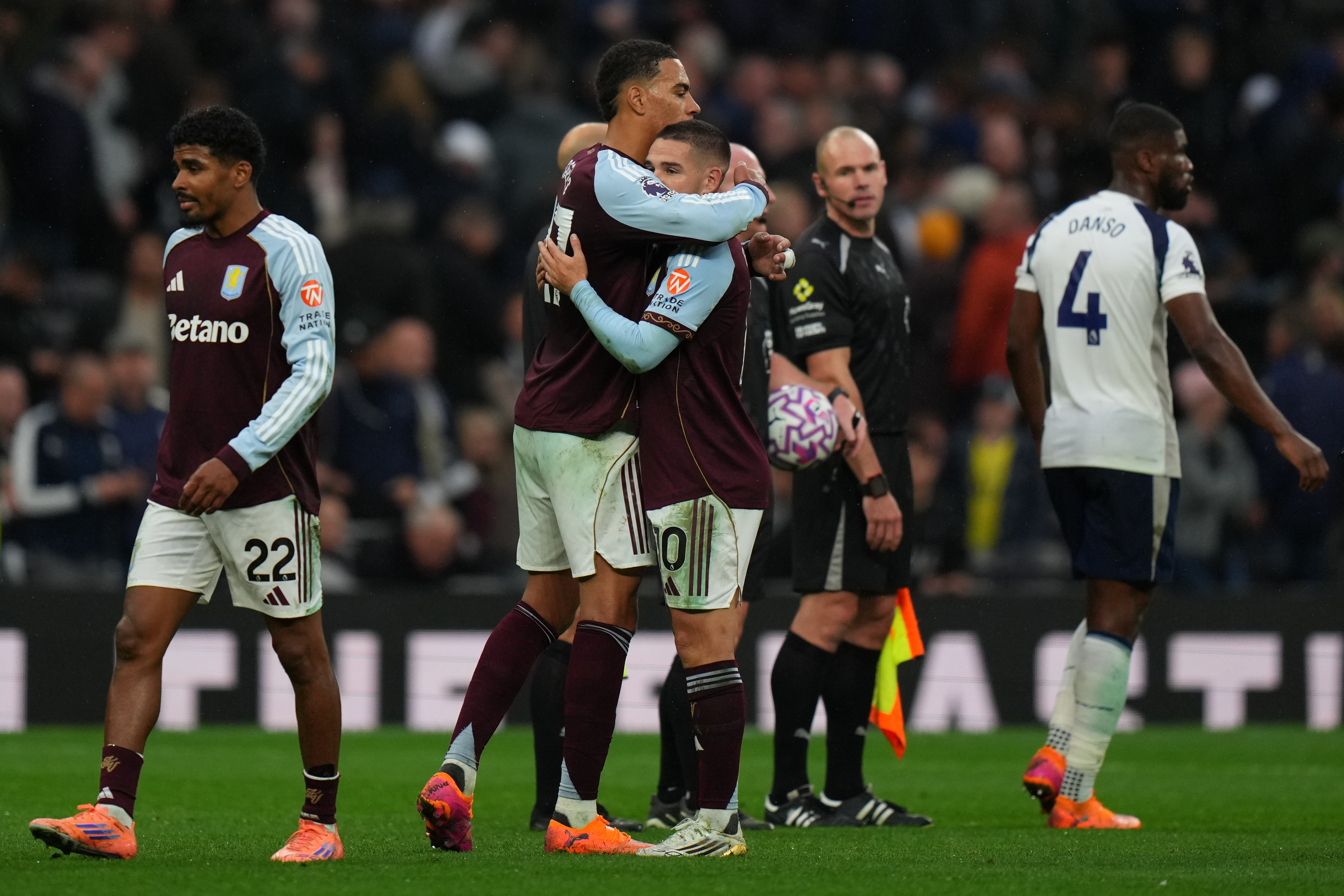Aston Villa's Emiliano Buendia, right and teammate Aston Villa's Donyell Malen embrace at the end of the English Premier League soccer match between Tottenham Hotspur and Aston Villa in London, Sunday, Oct. 19, 2025.
