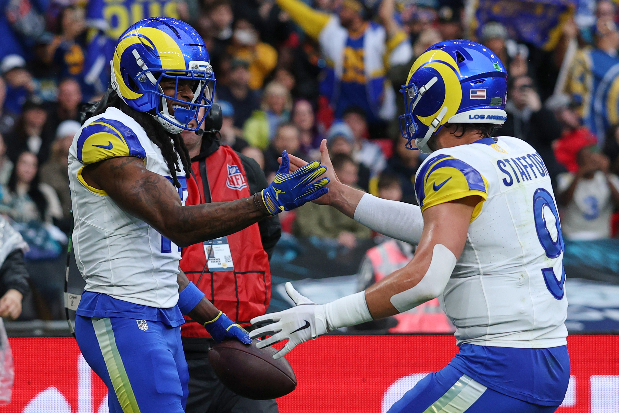 Los Angeles Rams wide receiver Davante Adams (17) celebrates with Los Angeles Rams quarterback Matthew Stafford (9) after scoring a touchdown during the first half of an NFL football game between the Los Angeles Rams and the Jacksonville Jaguars in London, Sunday, Oct. 19, 2025.