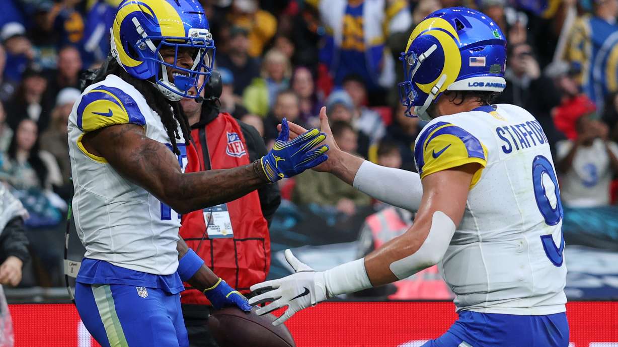 Los Angeles Rams wide receiver Davante Adams (17) celebrates with Los Angeles Rams quarterback Matthew Stafford (9) after scoring a touchdown during the first half of an NFL football game between the Los Angeles Rams and the Jacksonville Jaguars in London, Sunday, Oct. 19, 2025.