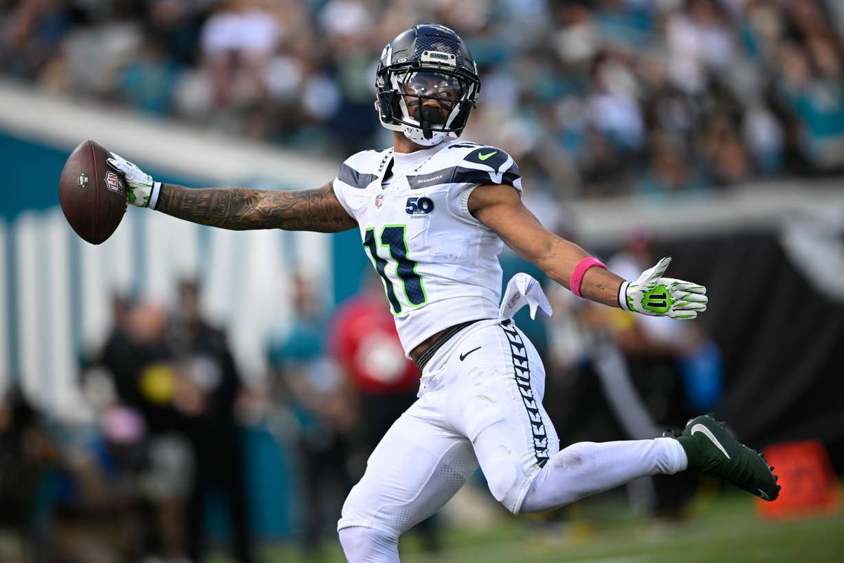 Seattle Seahawks wide receiver Jaxon Smith-Njigba (11) catches a touchdown pass on a 61-yard pass play during the first half of an NFL football game against the Jacksonville Jaguars, Sunday, Oct. 12 2025, in Jacksonville, Fla.
