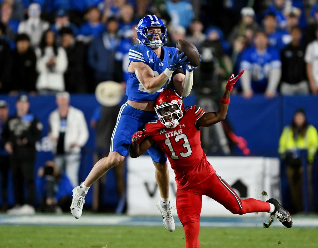 BYU safety Tanner Wall (28) intercepts a pass over Utah running back Daniel Bray (13) as BYU and Utah play at LaVell Edwards Stadium in Provo on Saturday, Oct. 18, 2025.