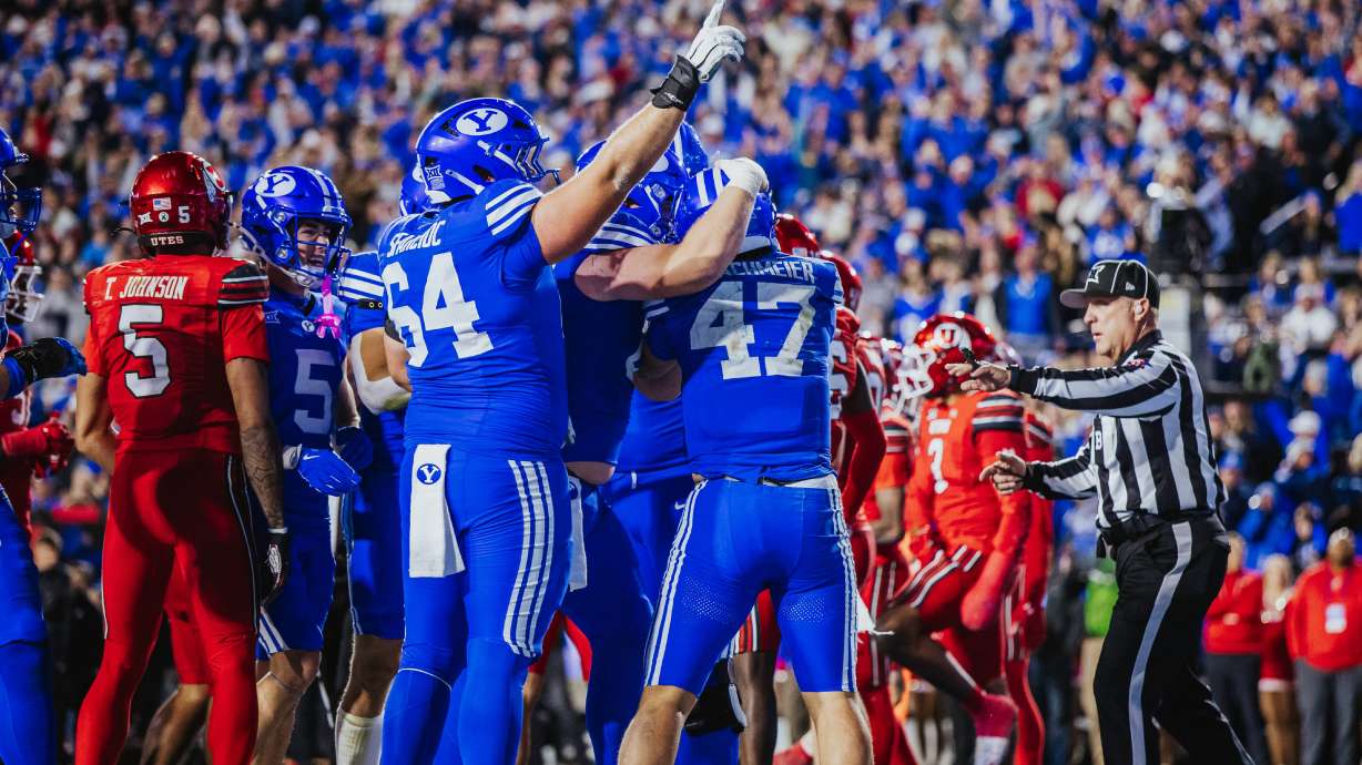 BYU offensive lineman Kyle Sfarcioc (64) celebrates with his teammates after Bear Bachmeier scored on a 22-yard touchdown run in BYU's 24-21 win over rival Utah, Saturday, Oct. 18, 2025 at LaVell Edwards Stadium in Provo, Utah.
