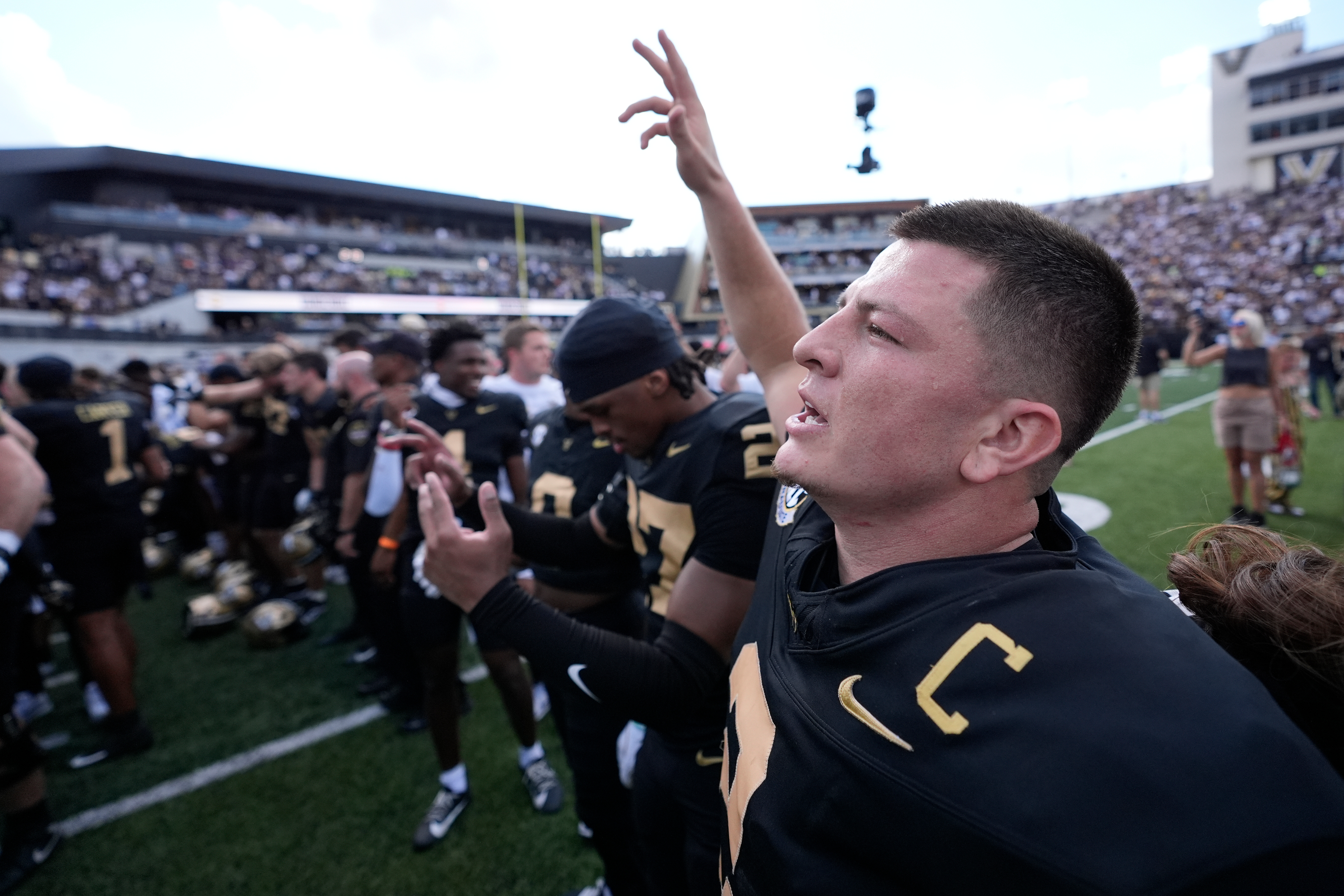 Vanderbilt quarterback Diego Pavia, right, celebrates the team's win with teammates after an NCAA college football game against LSU, Saturday, Oct. 18, 2025, in Nashville, Tenn.