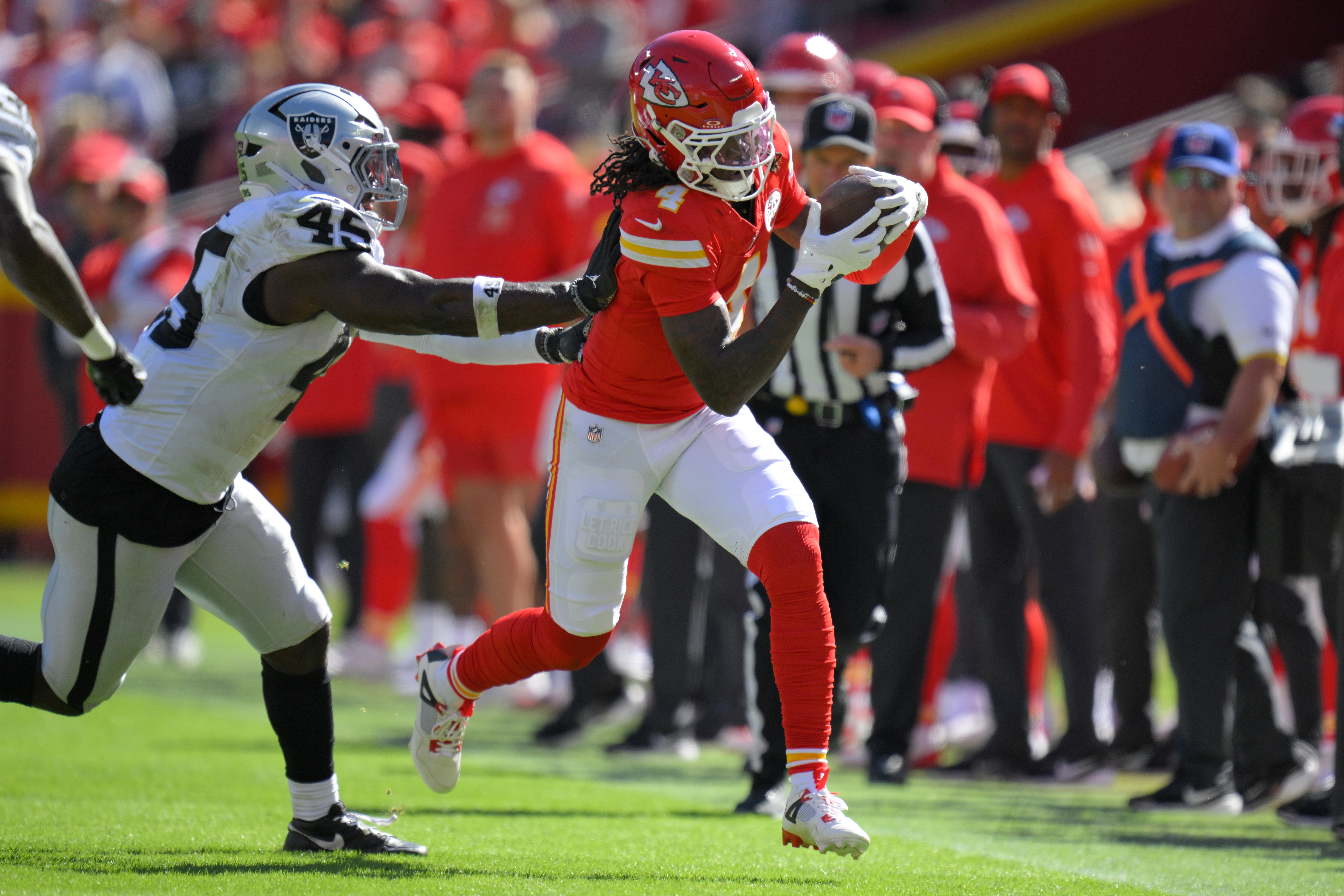 Kansas City Chiefs wide receiver Rashee Rice (4) is pushed out of bounds by Las Vegas Raiders linebacker Devin White (45) during the first half of an NFL football game Sunday, Oct. 19, 2025, in Kansas City, Mo. 