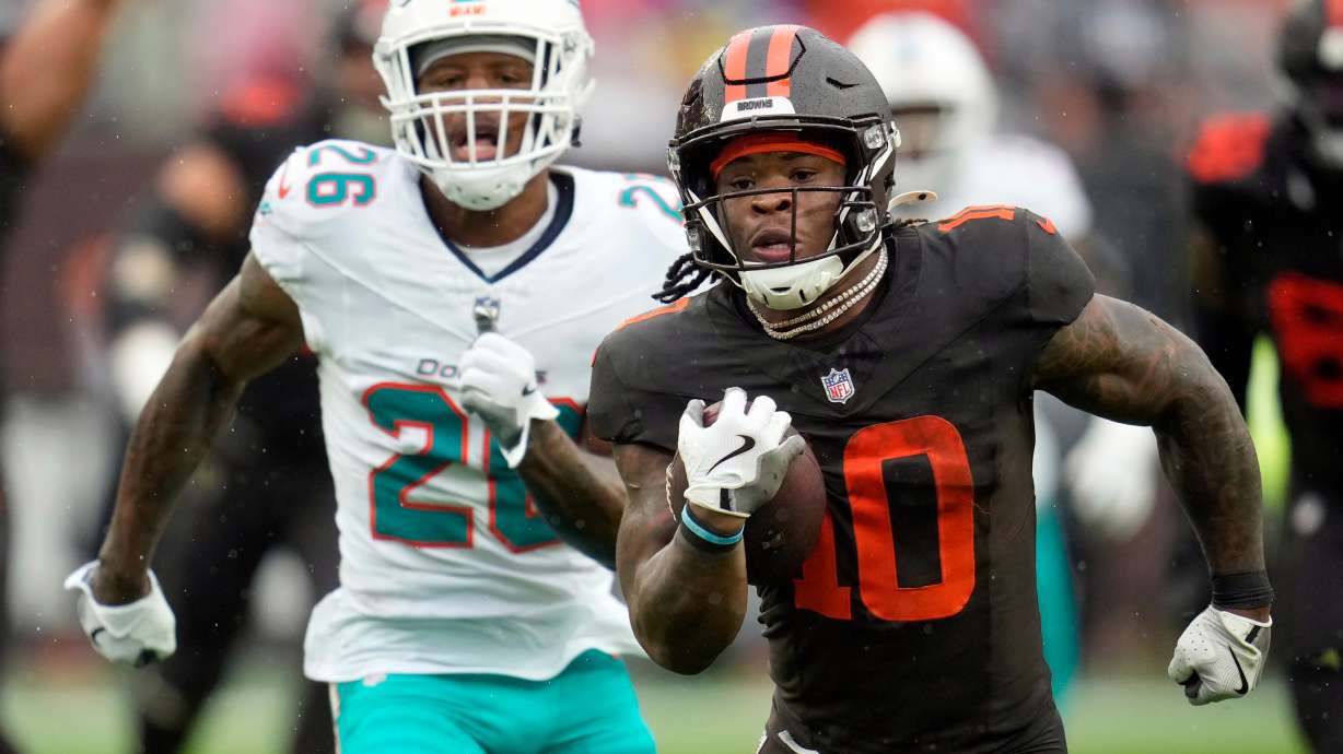 Cleveland Browns running back Quinshon Judkins (10) carries the ball ahead of Miami Dolphins cornerback Rasul Douglas (26) in the first half of an NFL football game in Cleveland, Sunday, Oct. 19, 2025.