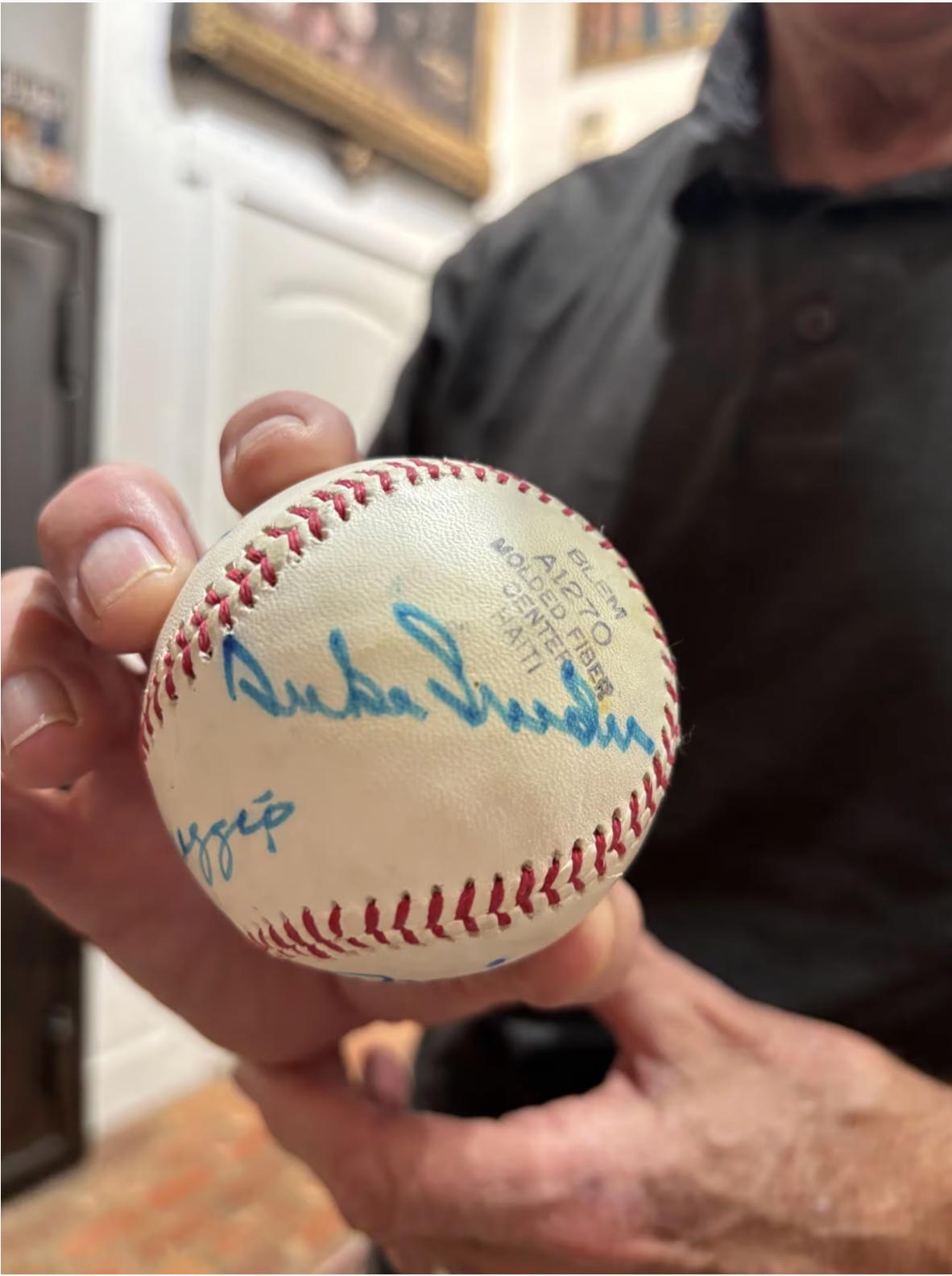 At Moon's Rare Books in Provo, columnist Lee Benson holds a baseball with Hall of Famer Duke Snider's autograph.