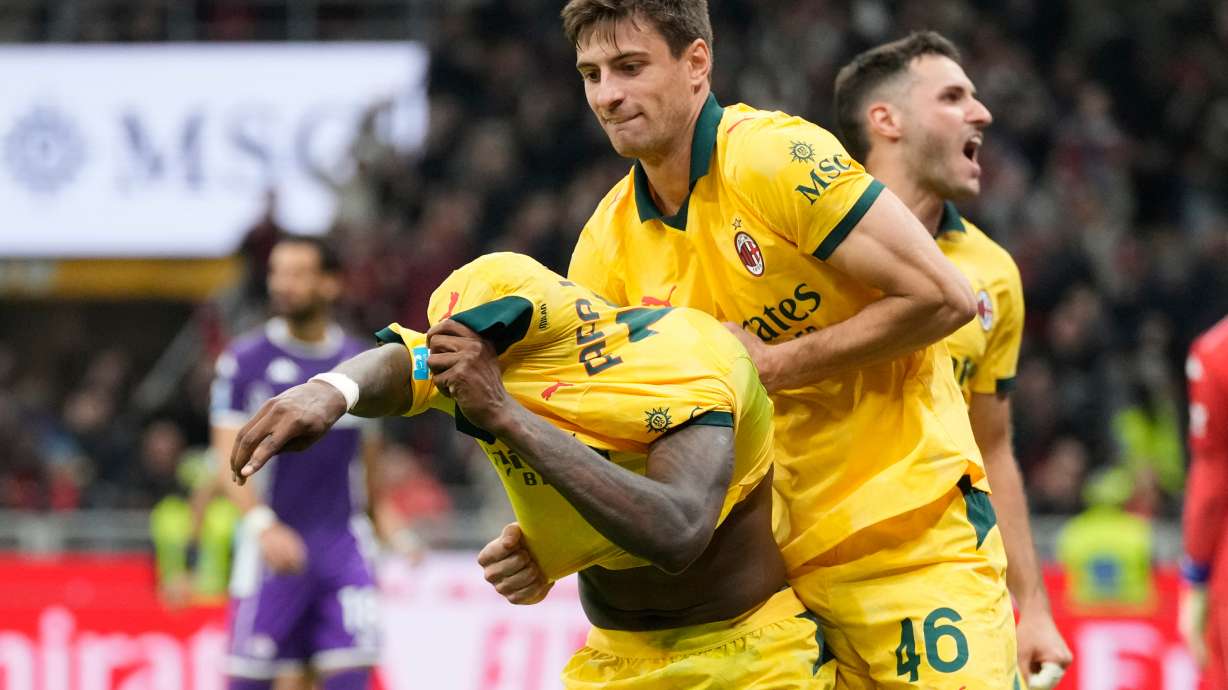 AC Milan's Rafael Leao, left, is congratulated after scoring his side's 2nd goal during a Serie A soccer match between AC Milan and Fiorentina in Milan, Italy, Sunday, Oct. 19, 2025.