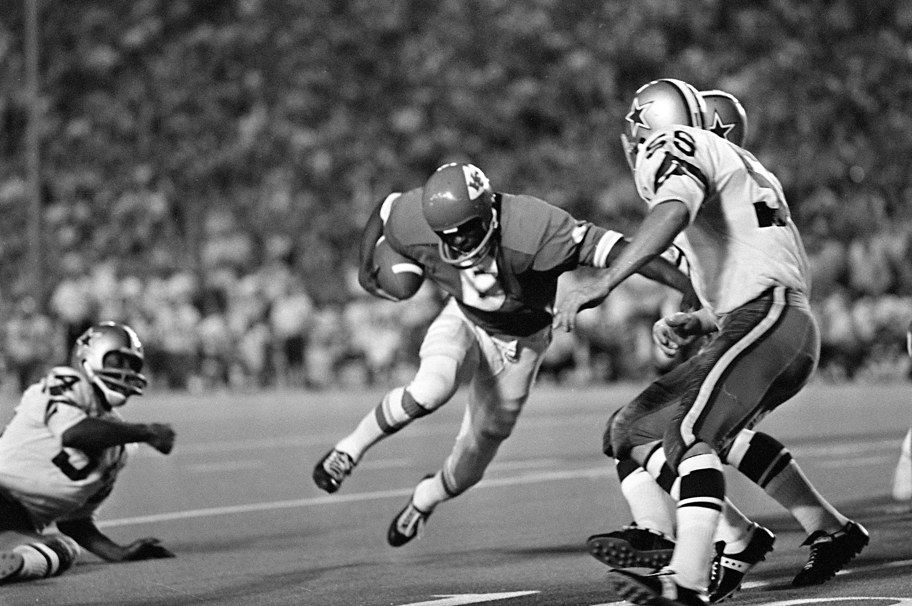 FILE - Warren McVea (6) Kansas City Chiefs running back is stopped on an end run by Dallas Cowboy Leroy Jordan (55) in the first quarter action in Dallas, Sept. 5, 1970.
