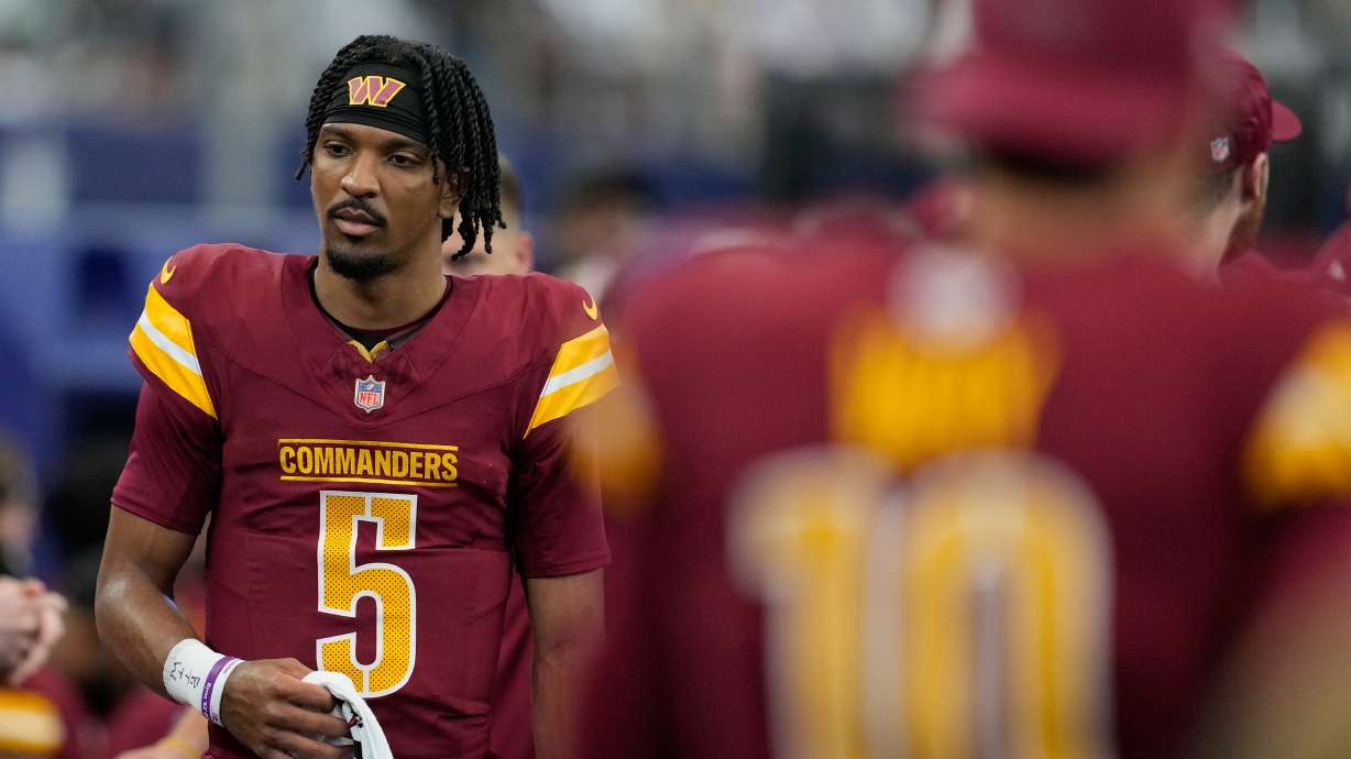 Washington Commanders quarterback Jayden Daniels walks on the sideline during the first half of an NFL football game against the Dallas Cowboys Sunday, Oct. 19, 2025, in Arlington, Texas.