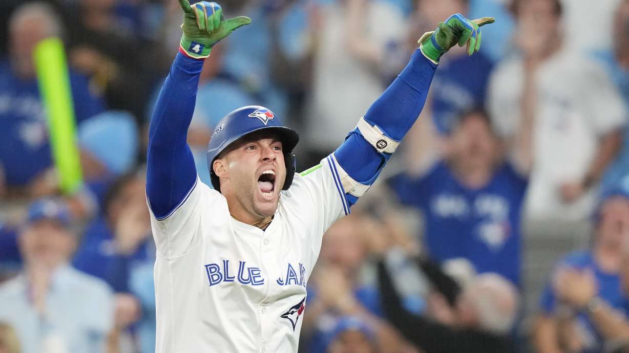Toronto Blue Jays' George Springer celebrates after hitting a three-run home run against the Seattle Mariners during the seventh inning in Game 7 of baseball's American League Championship Series in Toronto, Monday, Oct. 20, 2025.