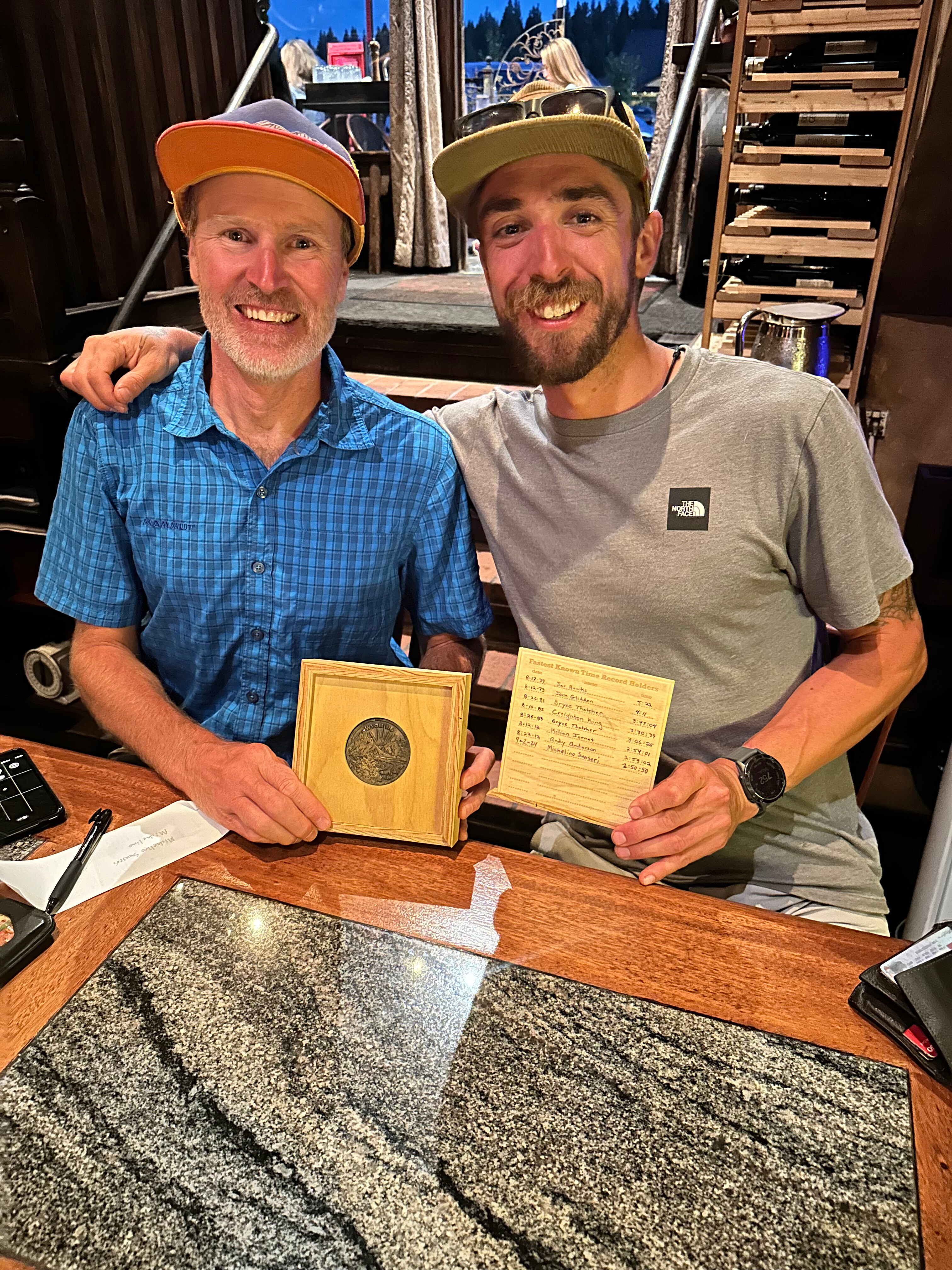 Michelino Sunseri, right, accepts a ceremonial belt buckle from Andy Anderson on Sept. 6, 2024, in Truckee, Calif., after breaking Anderson's record time for running up and down Grand Teton mountain in Grand Teton National Park in Wyoming a few days earlier. 