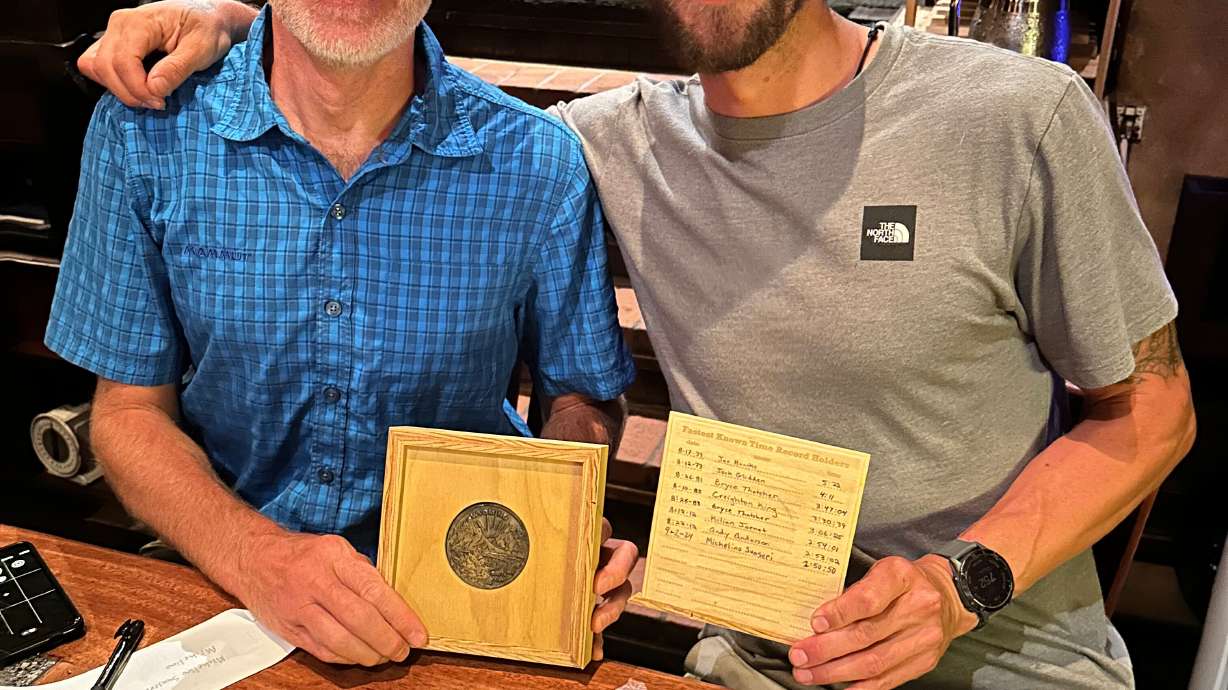 Michelino Sunseri, right, accepts a ceremonial belt buckle from Andy Anderson on Sept. 6, 2024, in Truckee, Calif., after breaking Anderson's record time for running up and down Grand Teton mountain in Grand Teton National Park in Wyoming a few days earlier.