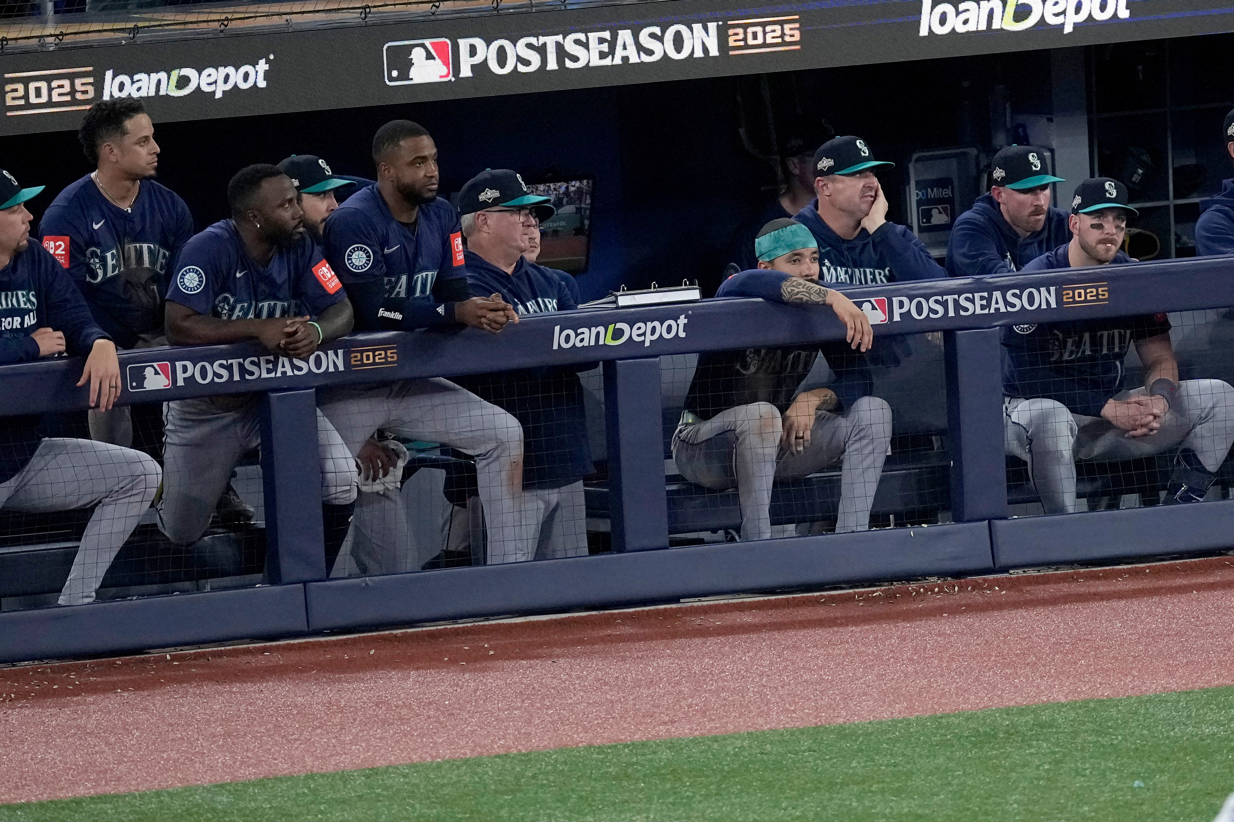 The Seattle Mariners watch from their dugout during the ninth inning in Game 7 of baseball's American League Championship Series against the Toronto Blue Jays, Monday, Oct. 20, 2025, in Toronto. 