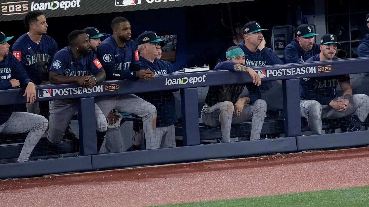 The Seattle Mariners watch from their dugout during the ninth inning in Game 7 of baseball's American League Championship Series against the Toronto Blue Jays, Monday, Oct. 20, 2025, in Toronto.