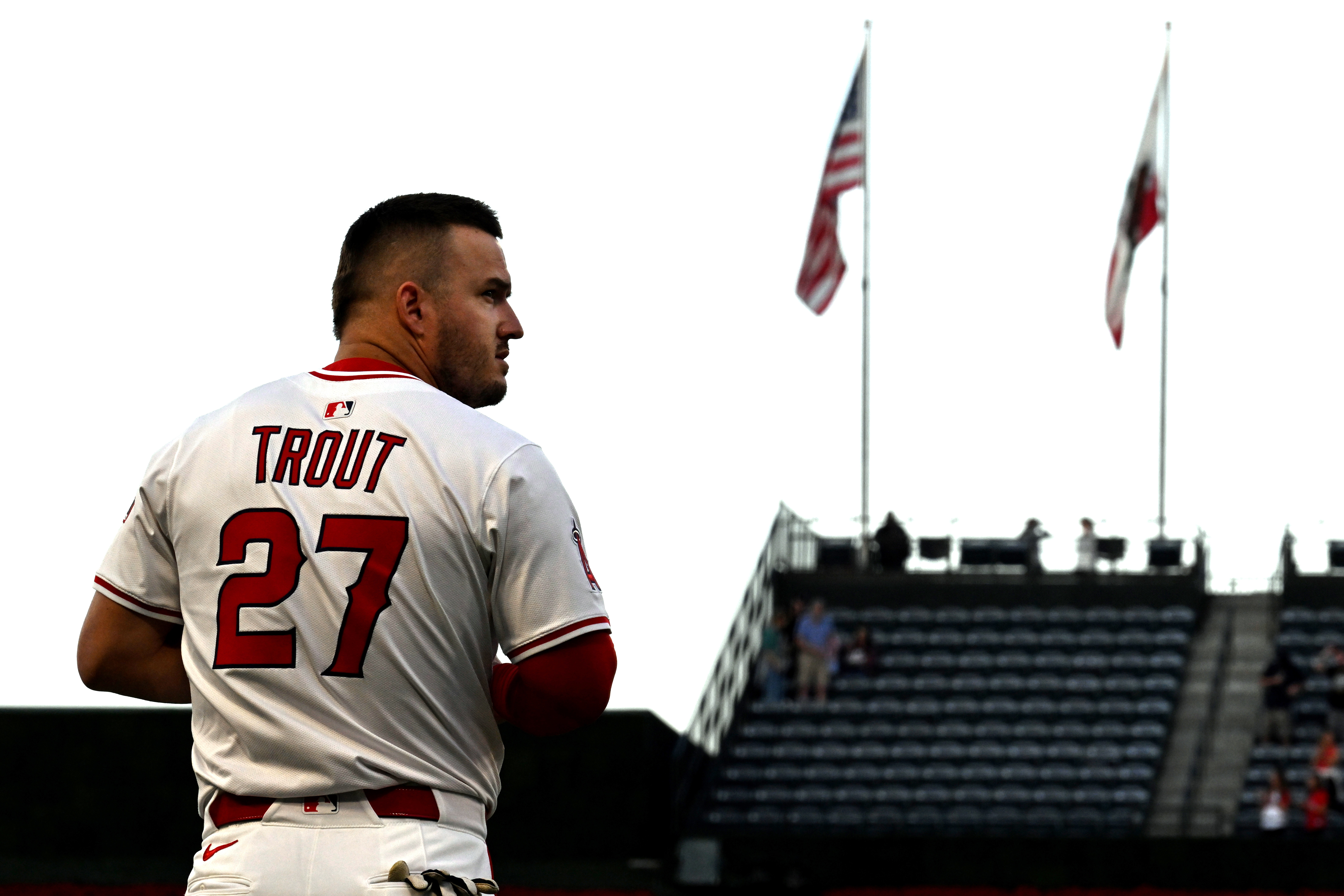 Los Angeles Angels outfielder Mike Trout (27) listens to the national anthem before a baseball game against the Royals Thursday, Sept. 25, 2025, in Anaheim, Calif. 