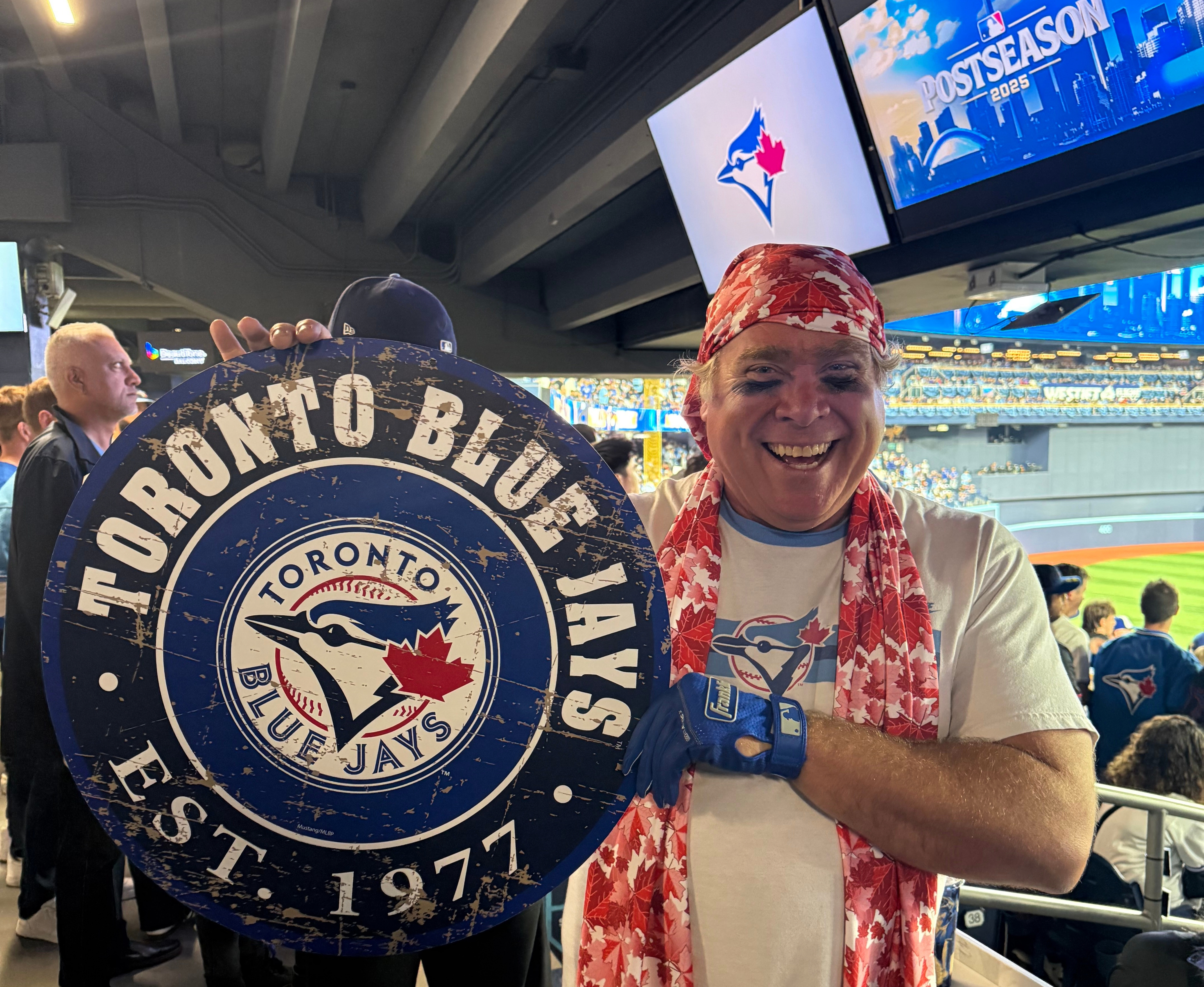 Toronto Blue Jays fan Geoffrey Fulton poses with his Blue Jays gear and maple leaf bandana during Game 7 of baseball's American League Championship Series between the Blue Jays and Seattle Mariners in Toronto, Monday, Oct. 20, 2025.
