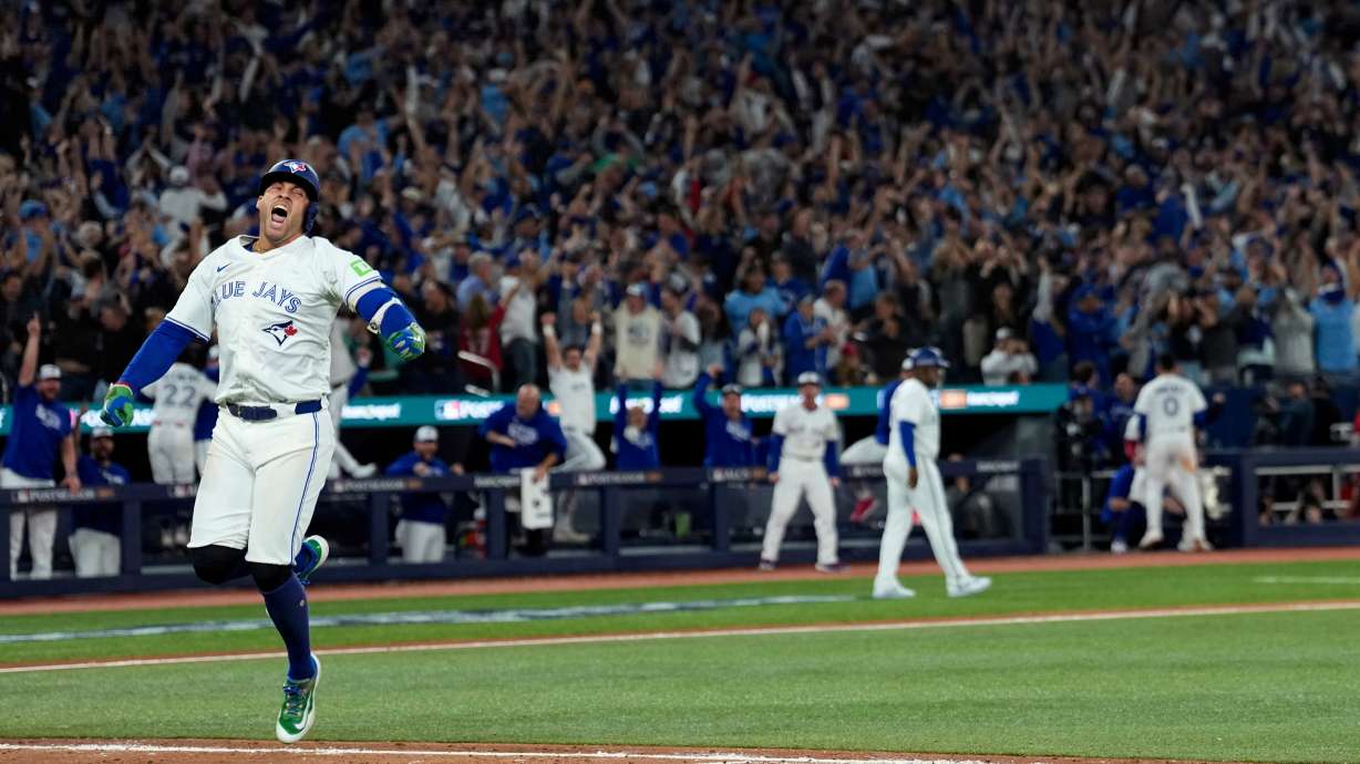 Toronto Blue Jays' George Springer reacts after hitting a three run home run against the Seattle Mariners during the seventh inning in Game 7 of baseball's American League Championship Series, Monday, Oct. 20, 2025, in Toronto.