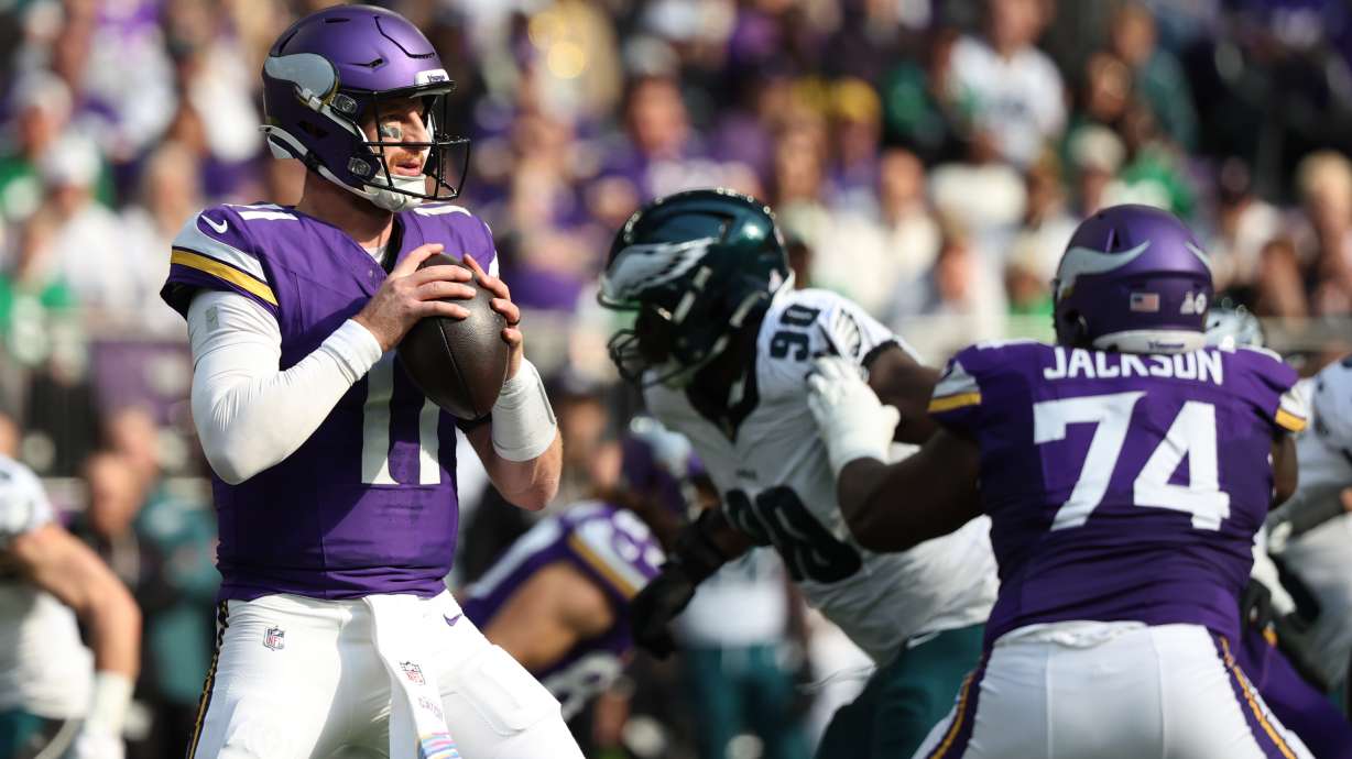 Minnesota Vikings quarterback Carson Wentz (11) prepares to throw a pass during the first half of an NFL football game against the Philadelphia Eagles, Sunday, Oct. 19, 2025, in Minneapolis.