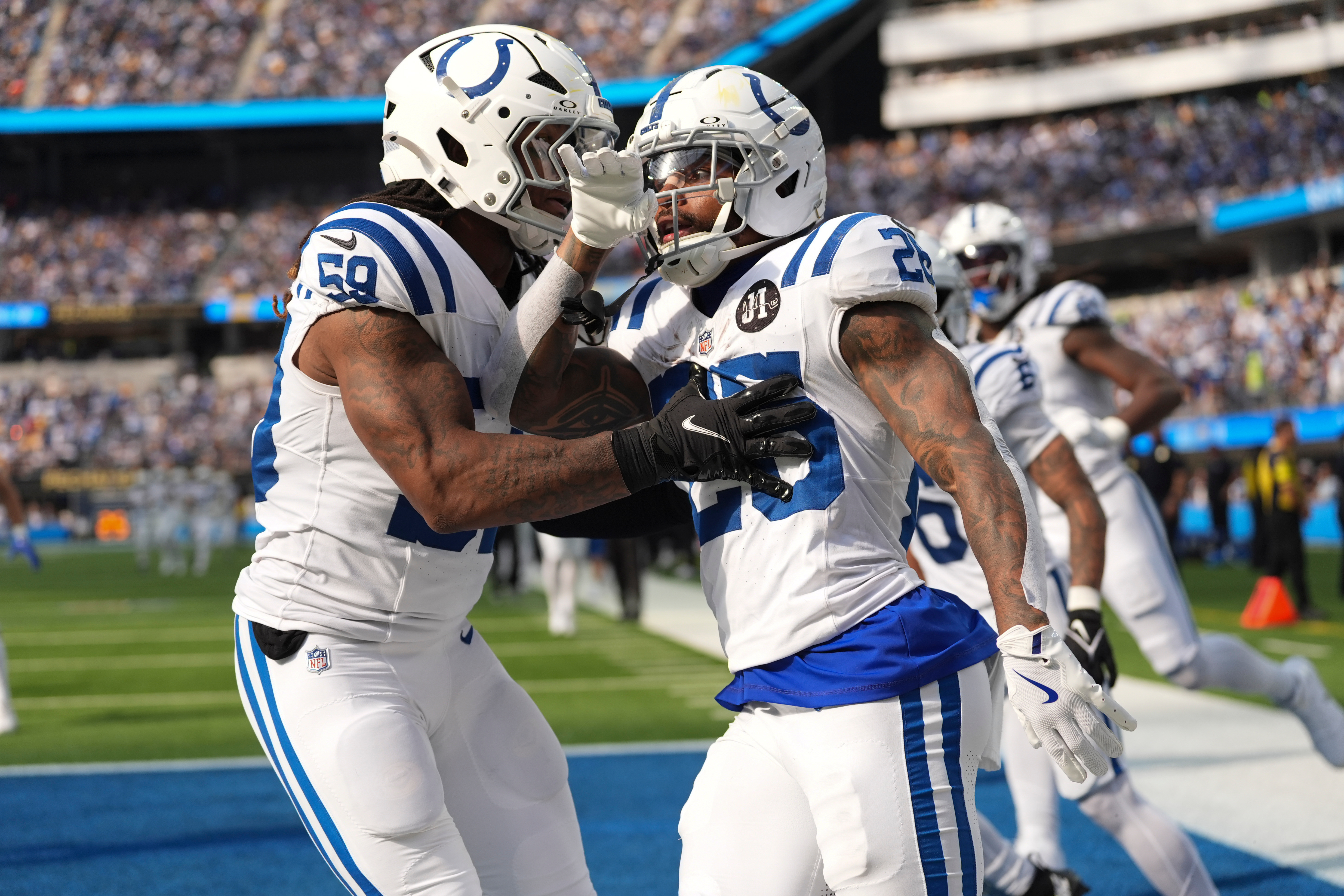 Indianapolis Colts running back Ameer Abdullah (26) celebrates a kickoff return with linebacker Buddy Johnson (59) against the Los Angeles Chargers during the second half of an NFL football game Sunday, Oct. 19, 2025, in Inglewood, Calif. 