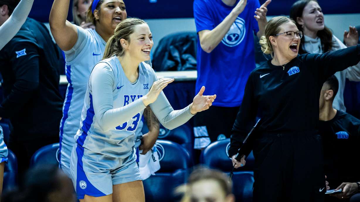 BYU forward Hattie Ogden cheers for her teammates during a Big 12 women's basketball game against Colorado in 2025.