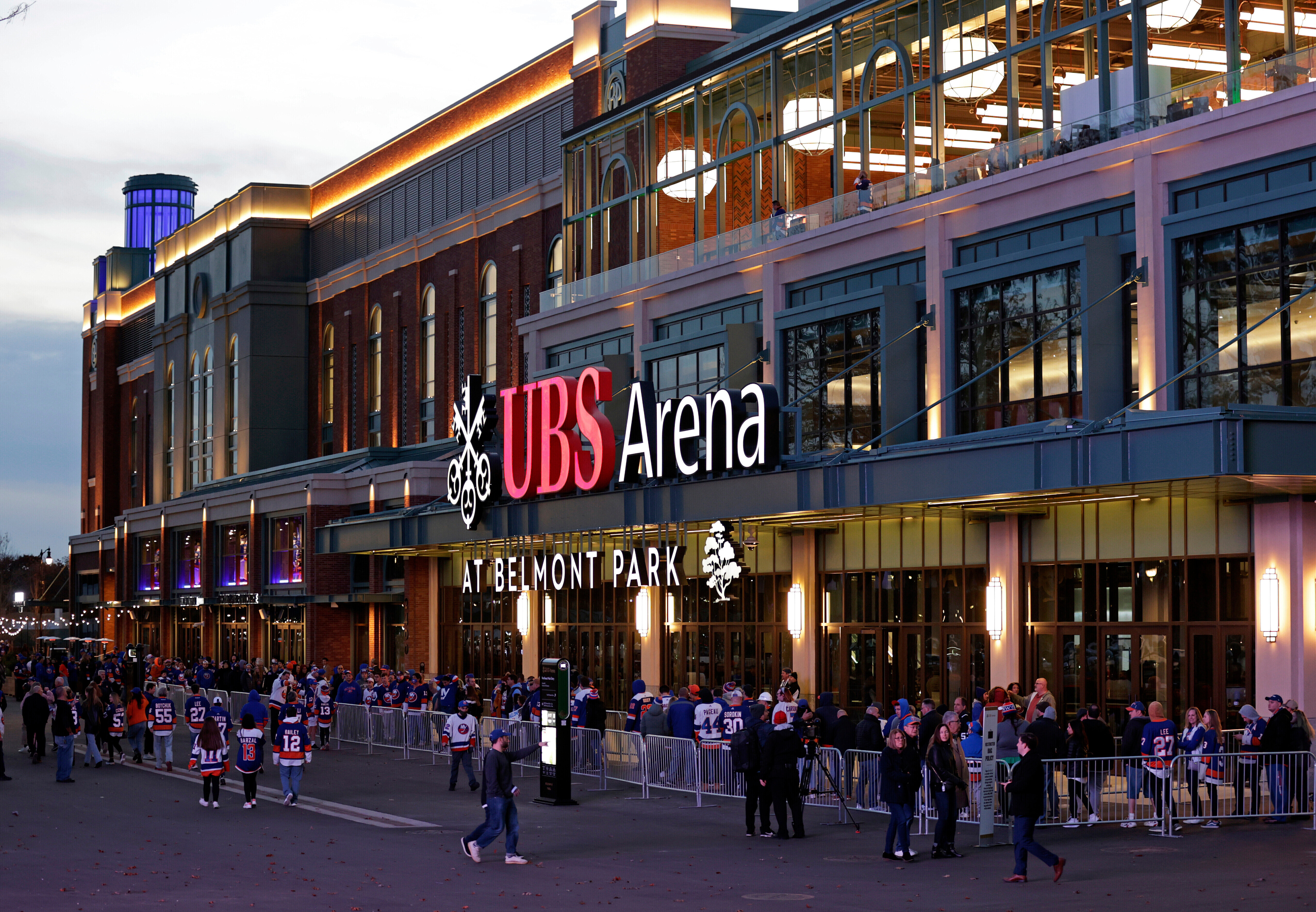 FILE - Fans wait to enter the new UBS Arena for the first New York Islanders NHL hockey game against the Calgary Flames, Nov. 20, 2021, in Elmont, N.Y. wld