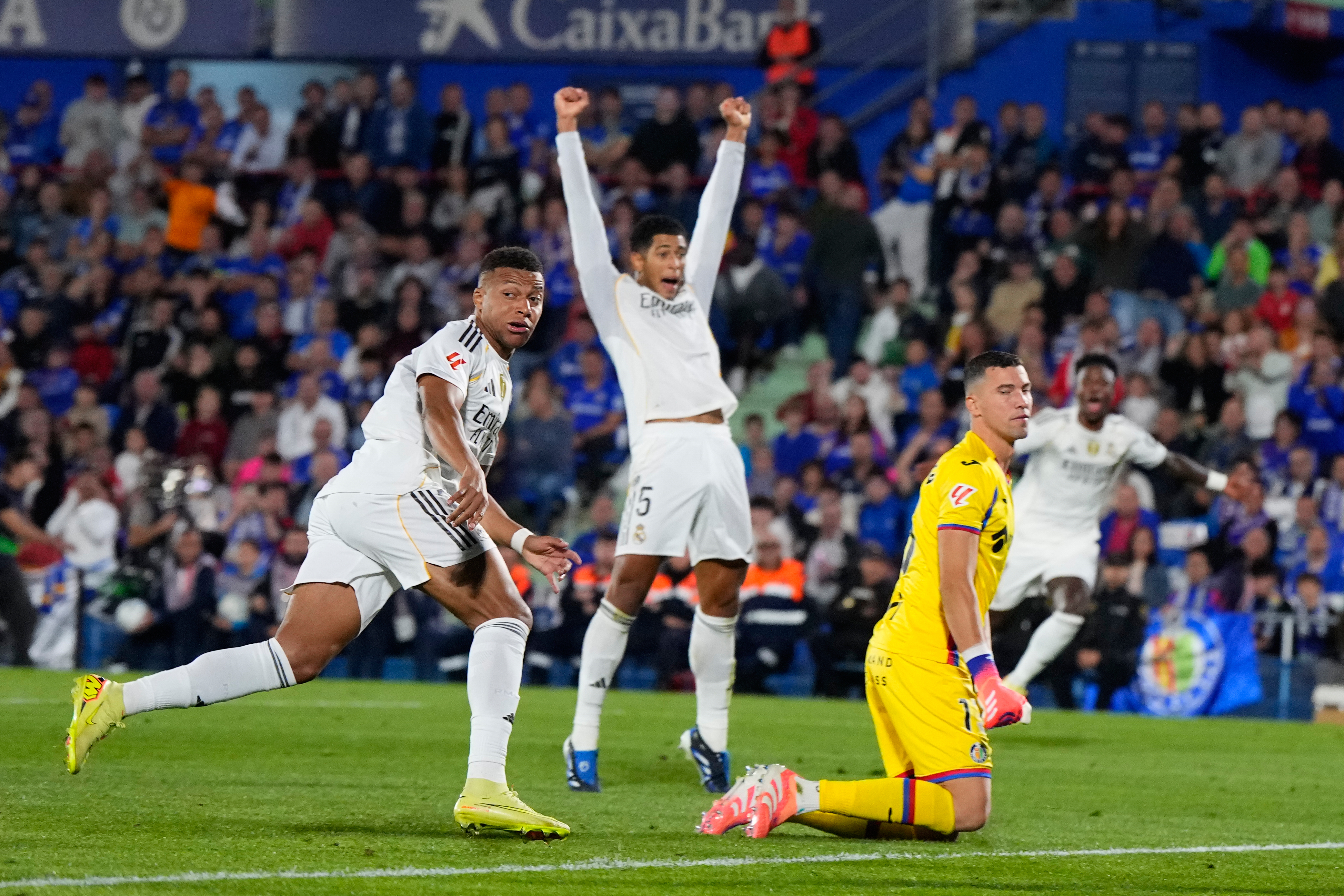 Real Madrid's Kylian Mbappe, left, looks at the ball after scoring during a La Liga soccer match between Getafe and Real Madrid in Getafe, Spain, Sunday, Oct. 19, 2025. 