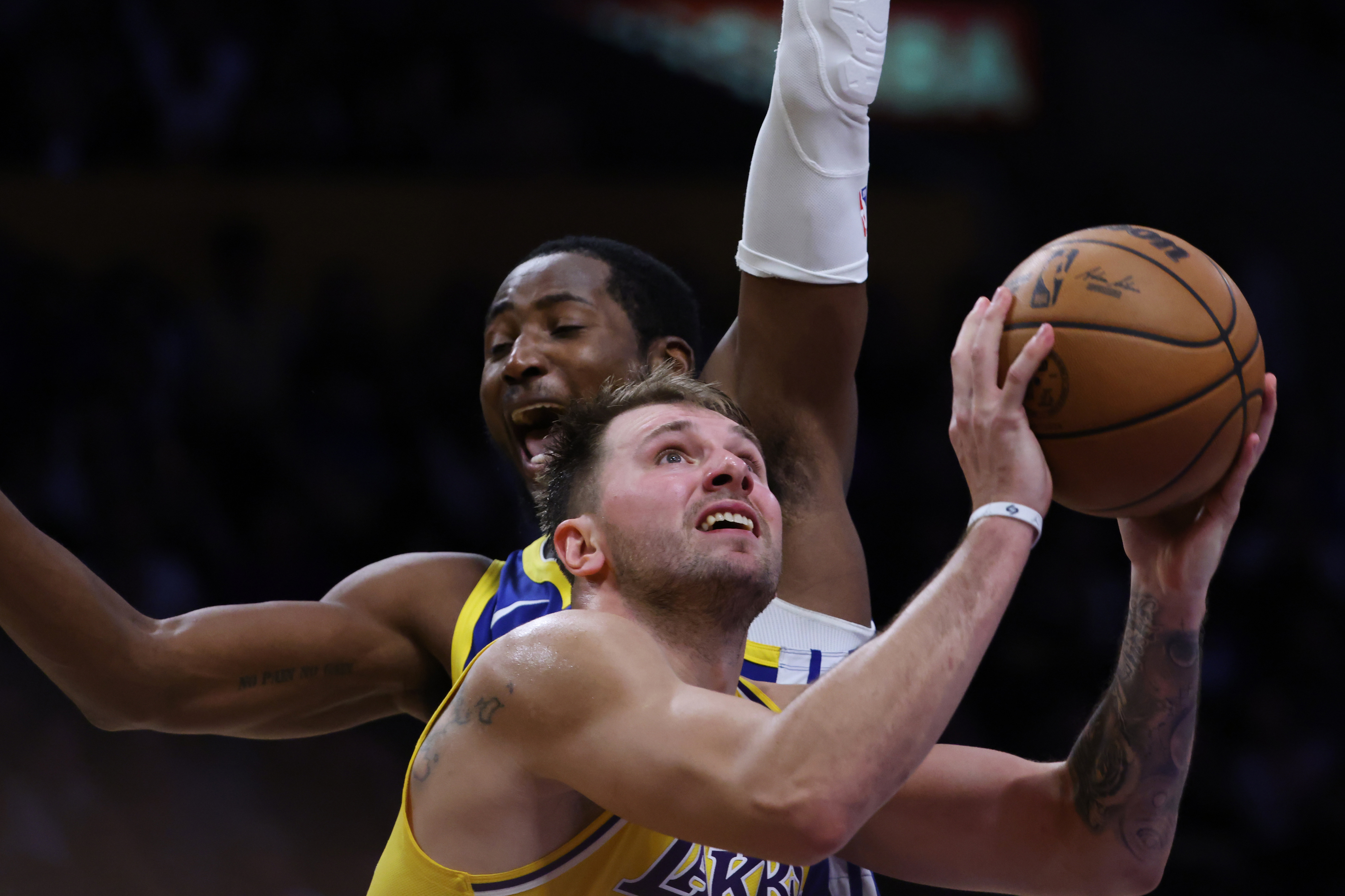 Los Angeles Lakers guard Luka Doncic (77) attempts a shot against the Golden State Warriors during the second half of an NBA basketball game Tuesday, Oct. 21, 2025, in Los Angeles. 