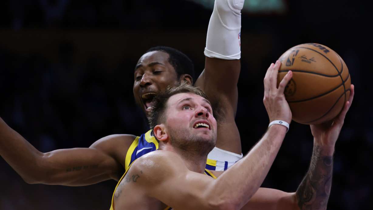 Los Angeles Lakers guard Luka Doncic (77) attempts a shot against the Golden State Warriors during the second half of an NBA basketball game Tuesday, Oct. 21, 2025, in Los Angeles.