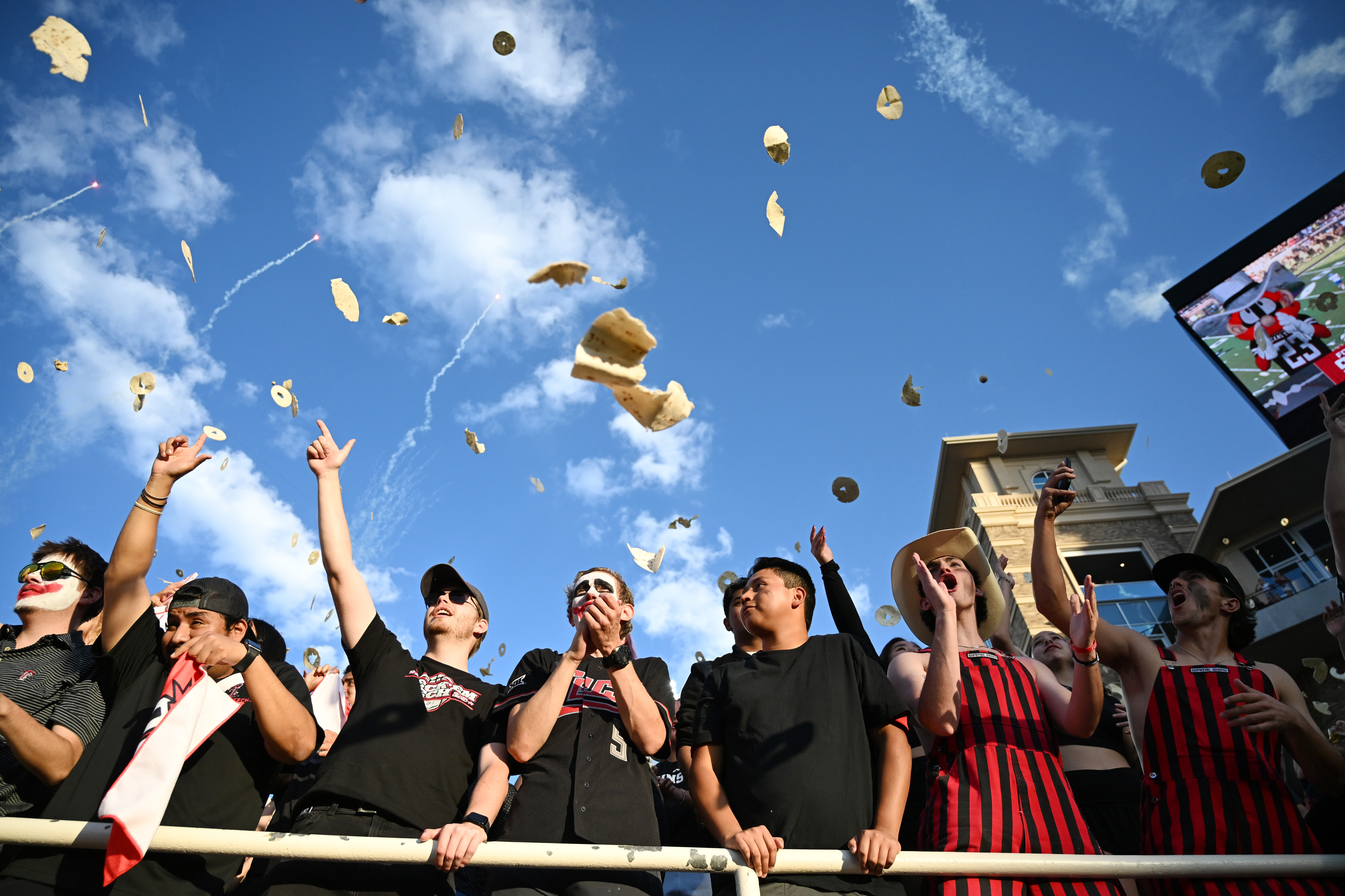 Texas Tech students throw tortillas before the NCAA college football game against Kansas, Saturday, Oct. 11, 2025, in Lubbock, Texas.