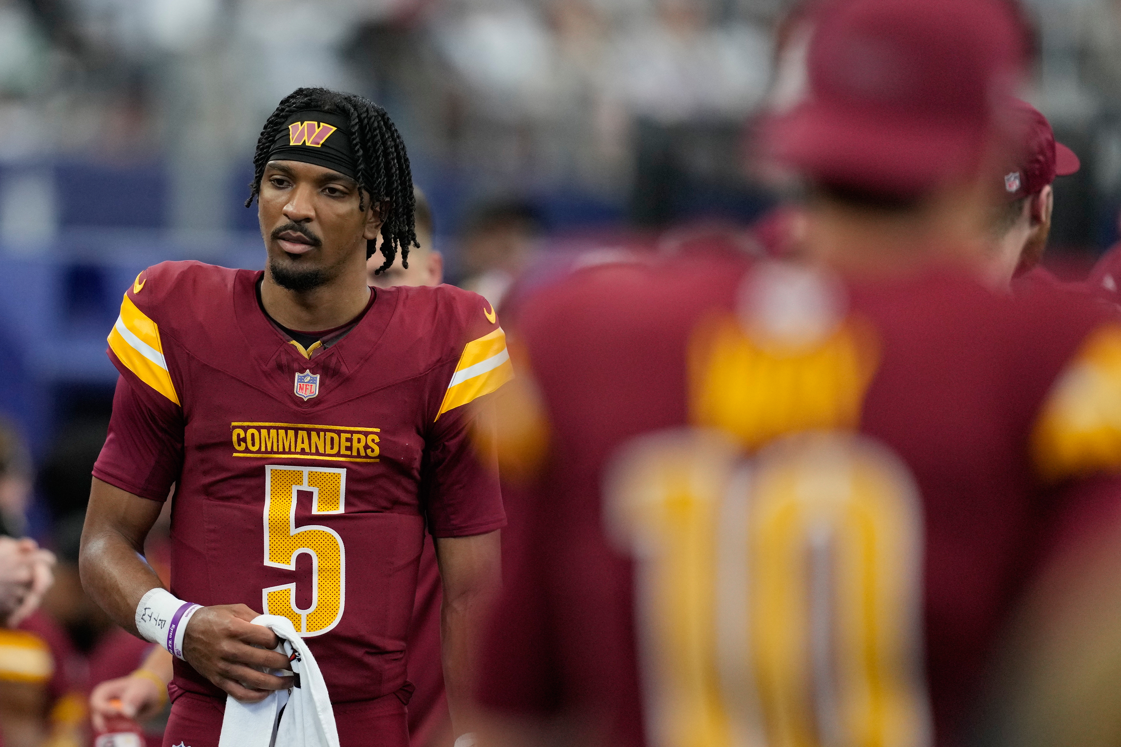 Washington Commanders quarterback Jayden Daniels walks on the sideline during the first half of an NFL football game against the Dallas Cowboys Sunday, Oct. 19, 2025, in Arlington, Texas. 