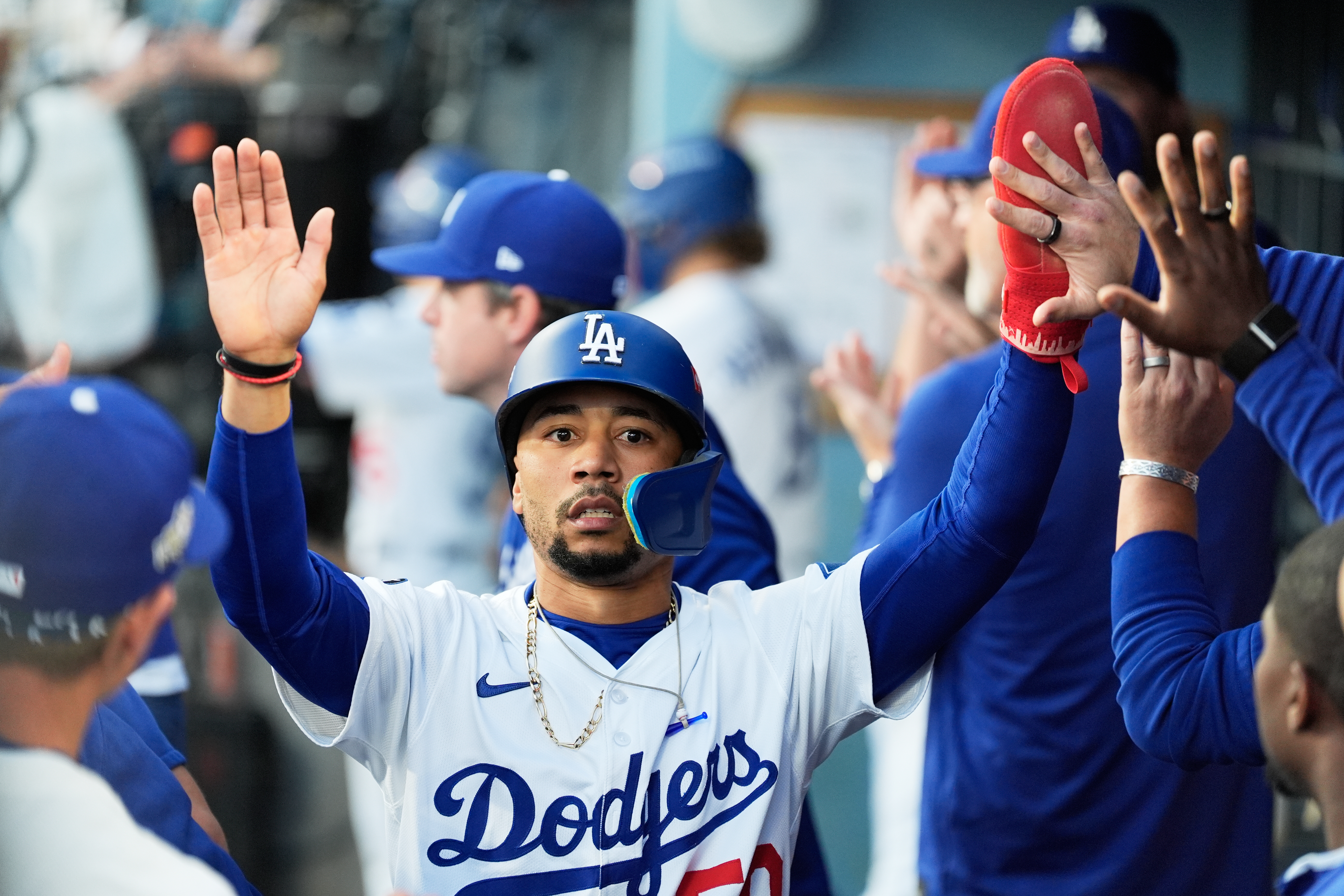 Los Angeles Dodgers' Mookie Betts celebrates in the dugout after scoring against the Milwaukee Brewers during the first inning in Game 4 of baseball's National League Championship Series, Friday, Oct. 17, 2025, in Los Angeles. 