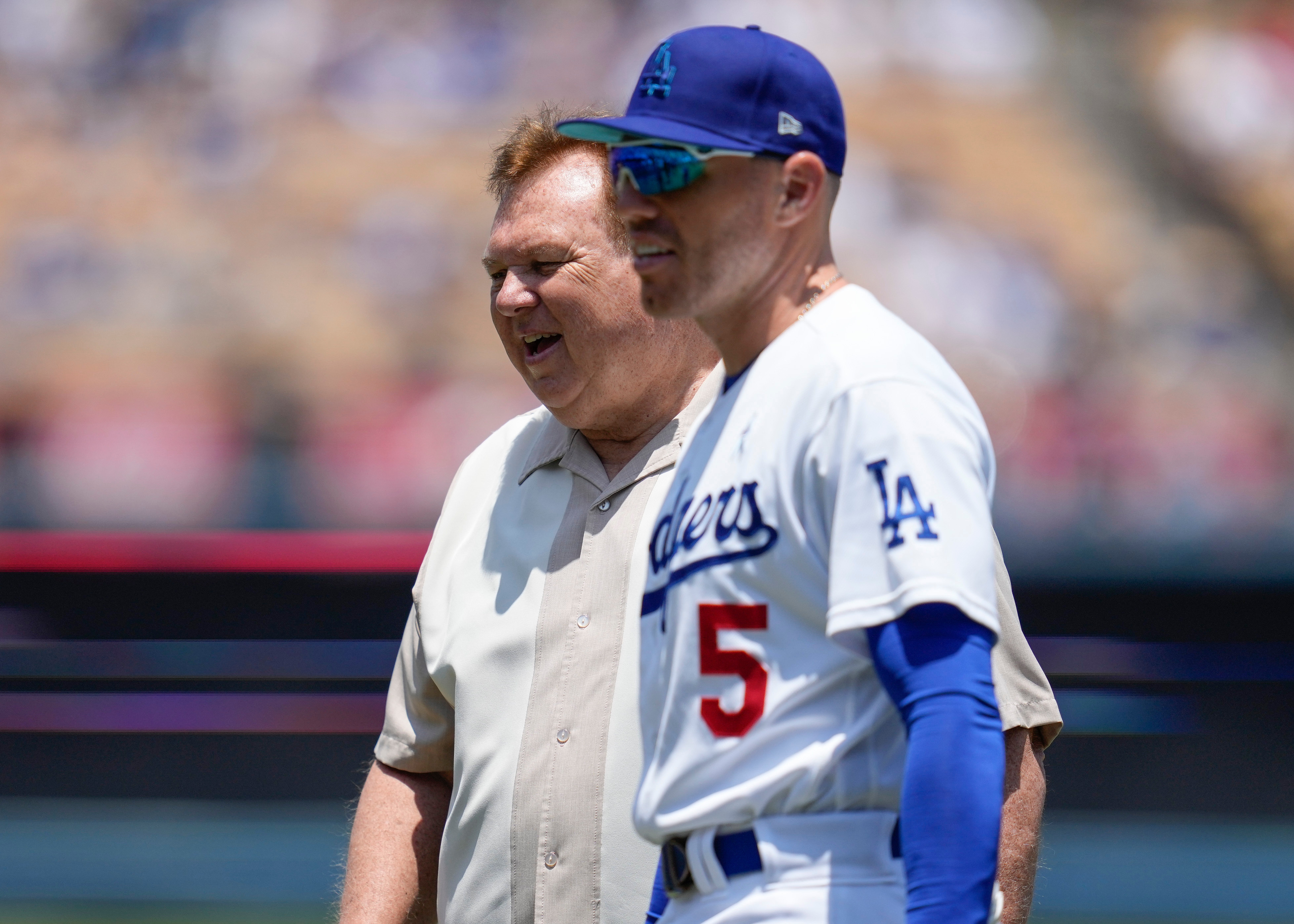 FILE - Los Angeles Dodgers first baseman Freddie Freeman (5) on the field walks with his father, Fred Freeman, before a baseball game against the San Francisco Giants in Los Angeles, Sunday, June 18, 2023.