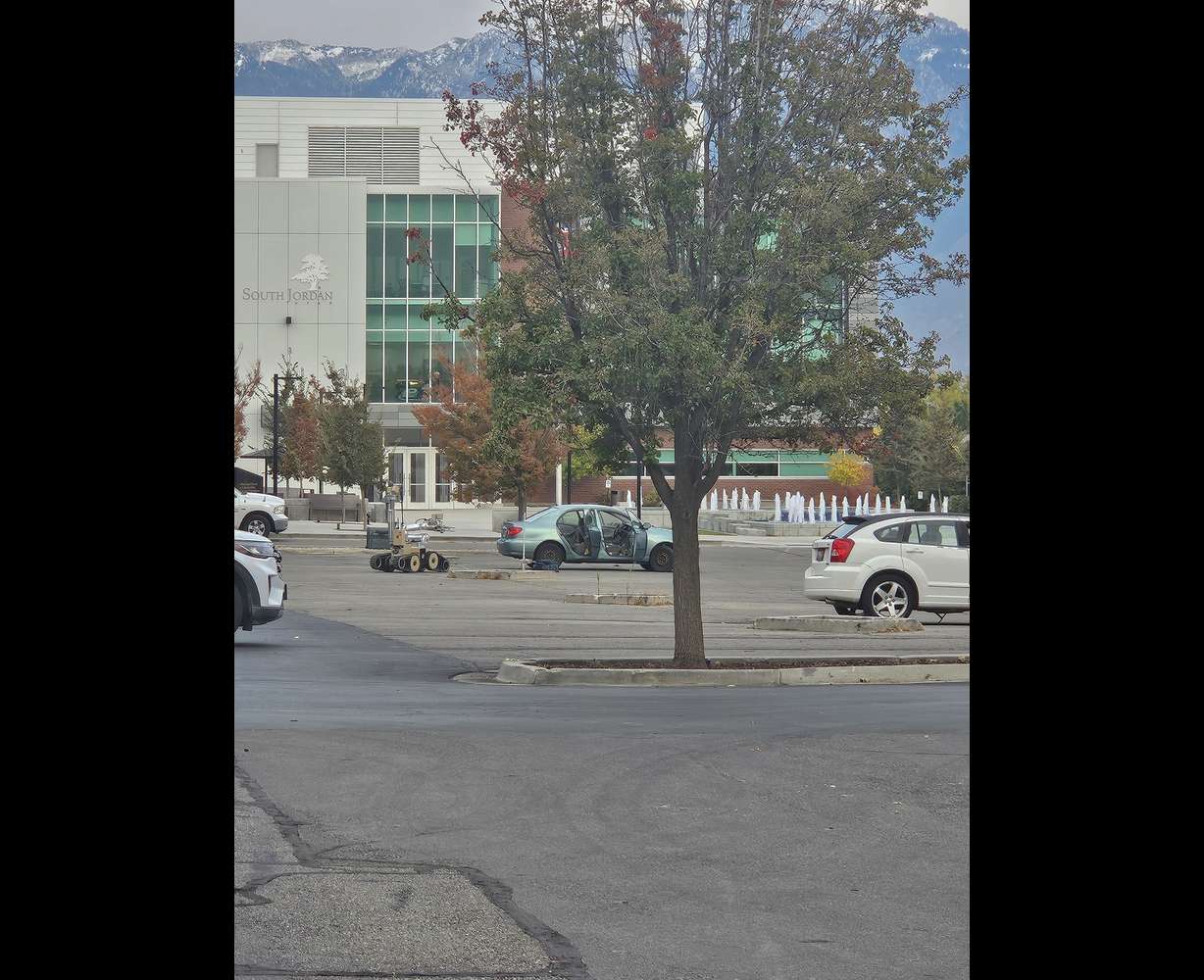 A bomb robot is seen as police investigate what was believed to be a bomb inside of a car in South Jordan Wednesday.