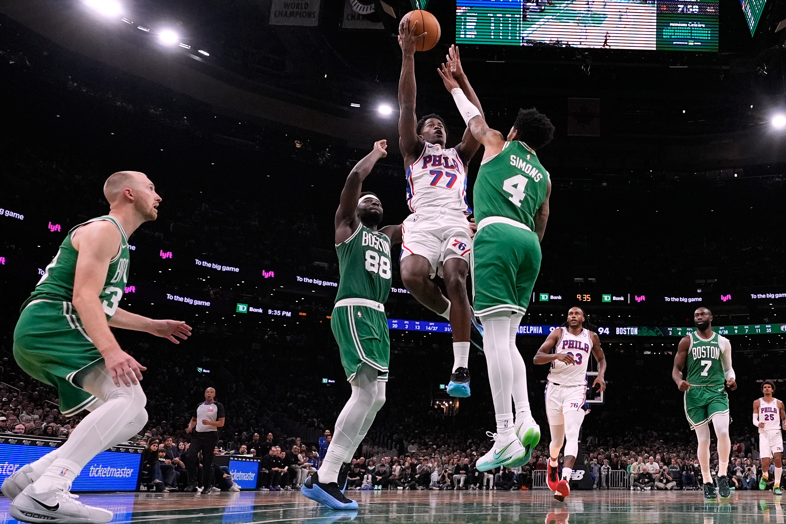 Philadelphia 76ers guard VJ Edgecombe (77) drives to the basket against Boston Celtics guard Anfernee Simons (4) during the second half of an NBA basketball game, Wednesday, Oct. 22, 2025, in Boston. 