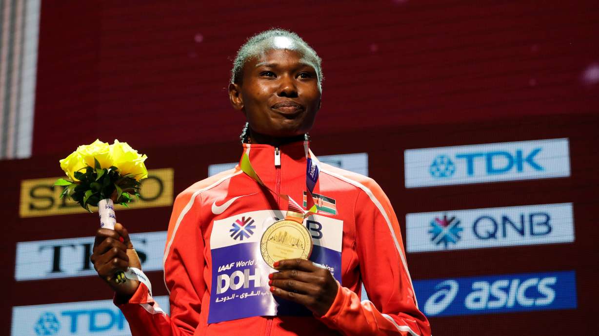 FILE - Kenya's Ruth Chepngetich poses with her gold medal during the medal ceremony for the women's marathon at the World Athletics Championships in Doha, Qatar, Sept. 28, 2019.