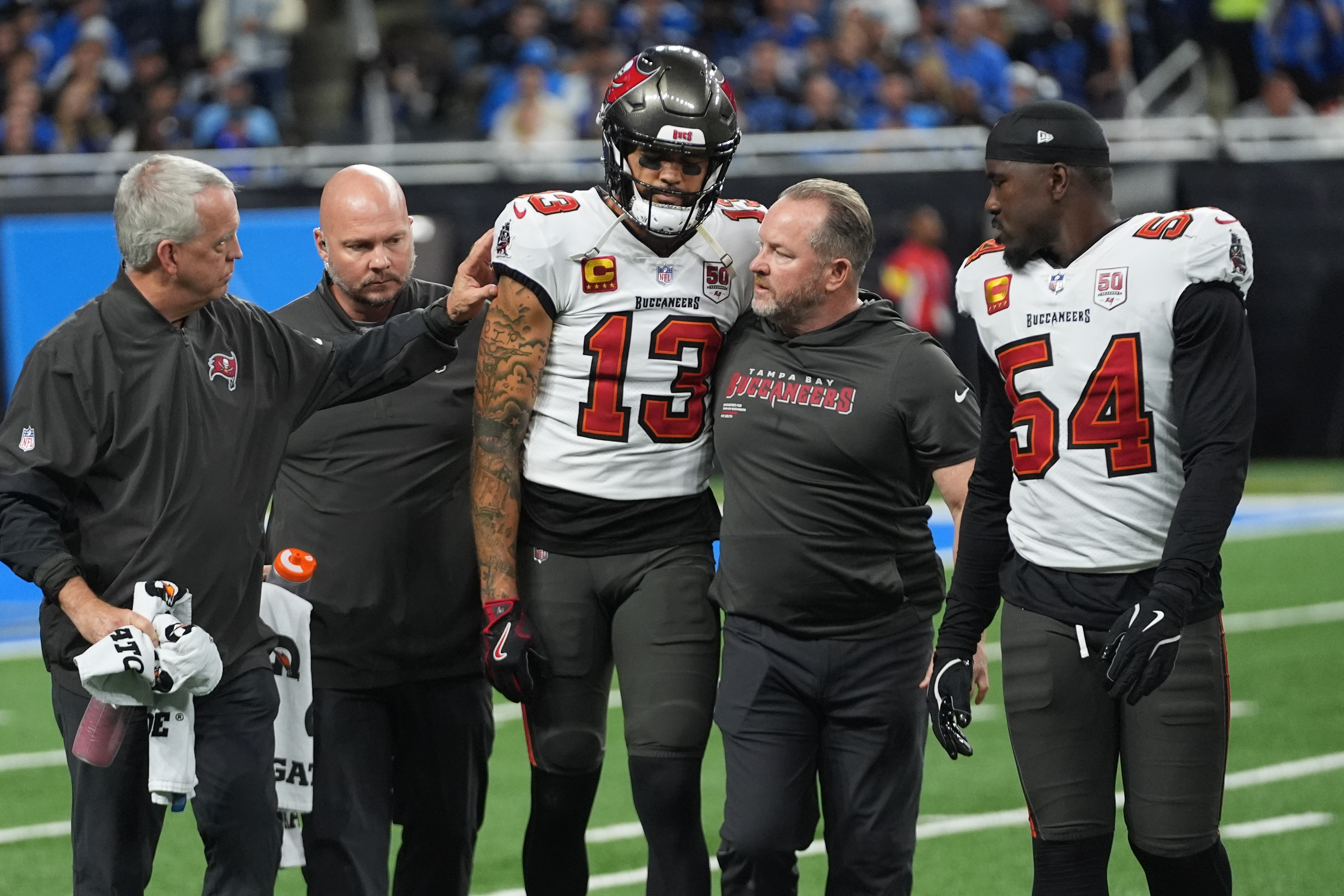 Tampa Bay Buccaneers wide receiver Mike Evans  is helped off the field after an injury during the first half of an NFL football game against the Detroit Lions, Monday, Oct. 20, 2025, in Detroit. AP Photo/Paul Sancya)