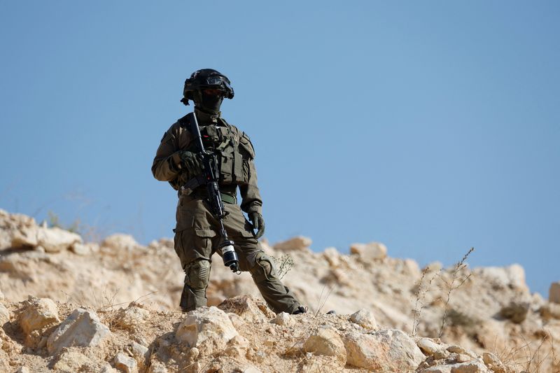 A member of the Israeli force stands guard during the olive harvest near Hebron, in the Israeli-occupied West Bank, Thursday. Vice President JD Vance said that President Donald Trump opposed annexation of the West Bank, calling it a "political stunt."