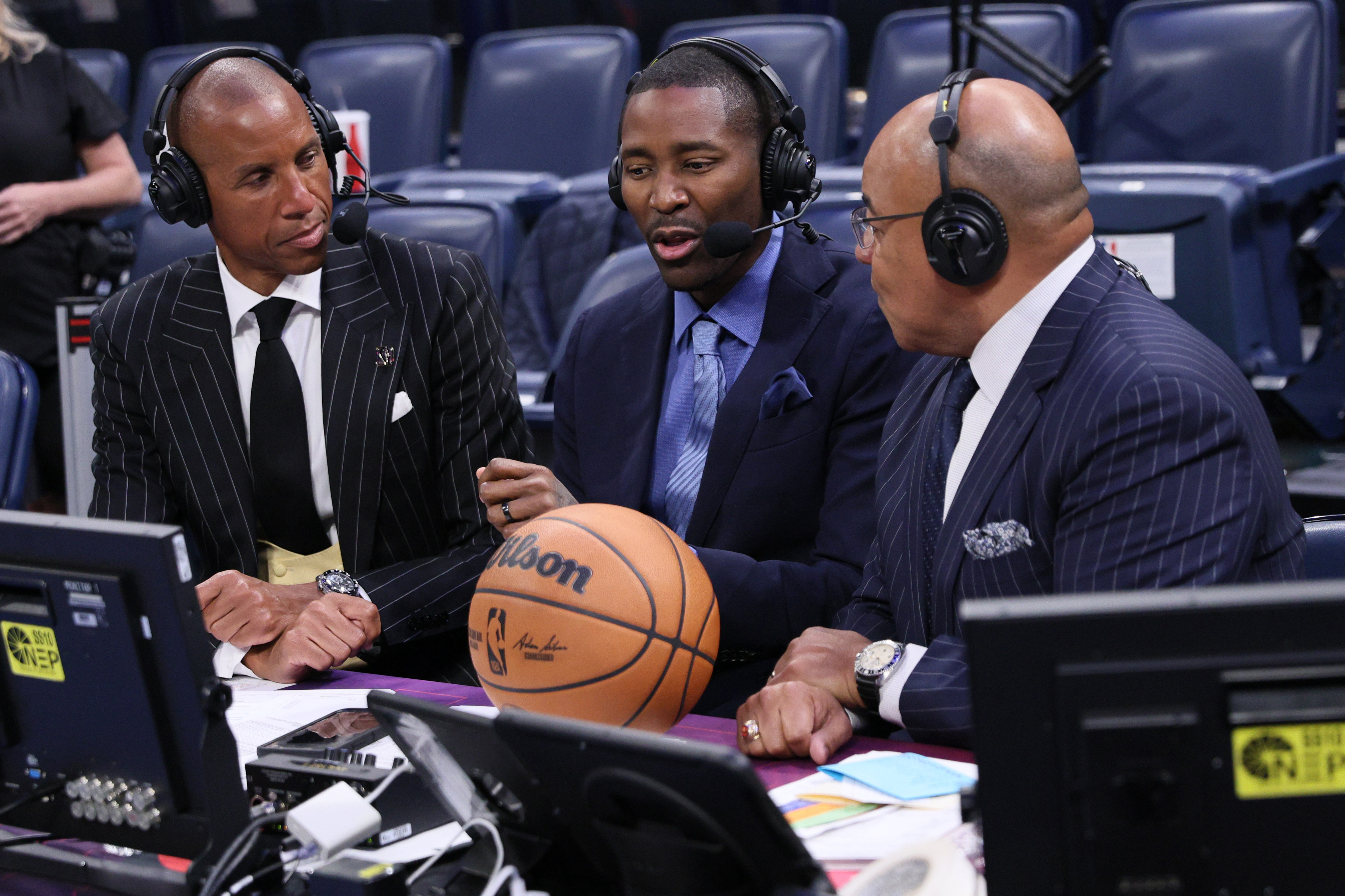 NBC Sports broadcasters, from left, Reggie Miller, Jamal Crawford and Mike Tirico talk after an NBA basketball game between the Houston Rockets and Oklahoma City Thunder, Tuesday, Oct. 21, 2025, in Oklahoma City. 